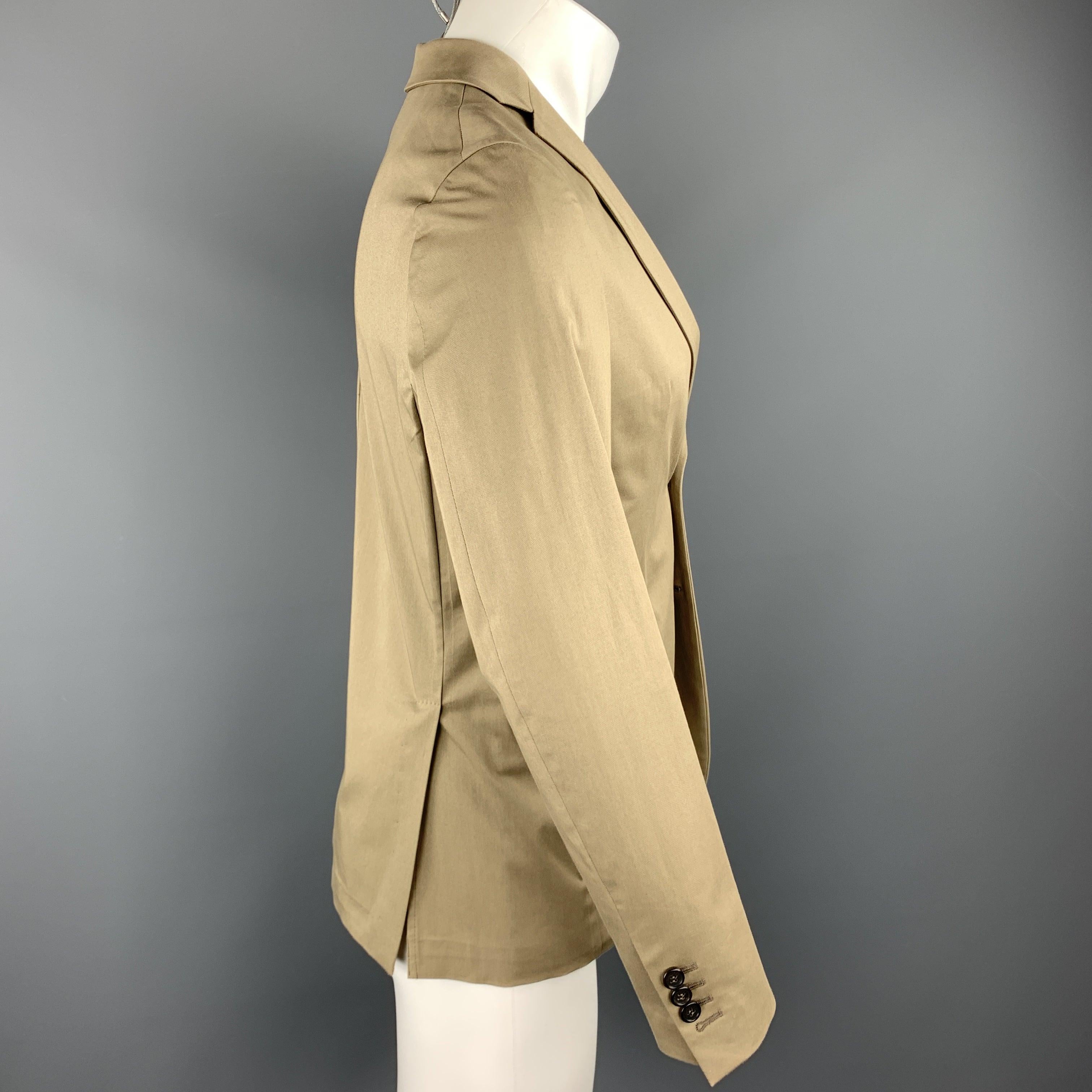 DSQUARED2 sport coat comes in a taupe cotton blend featuring a notch lapel style, flap pockets, and a two button closure. Made in Italy.Excellent
Pre-Owned Condition. 

Marked:   IT 46 

Measurements: 
 
Shoulder: 17 inches 
Chest: 38 inches