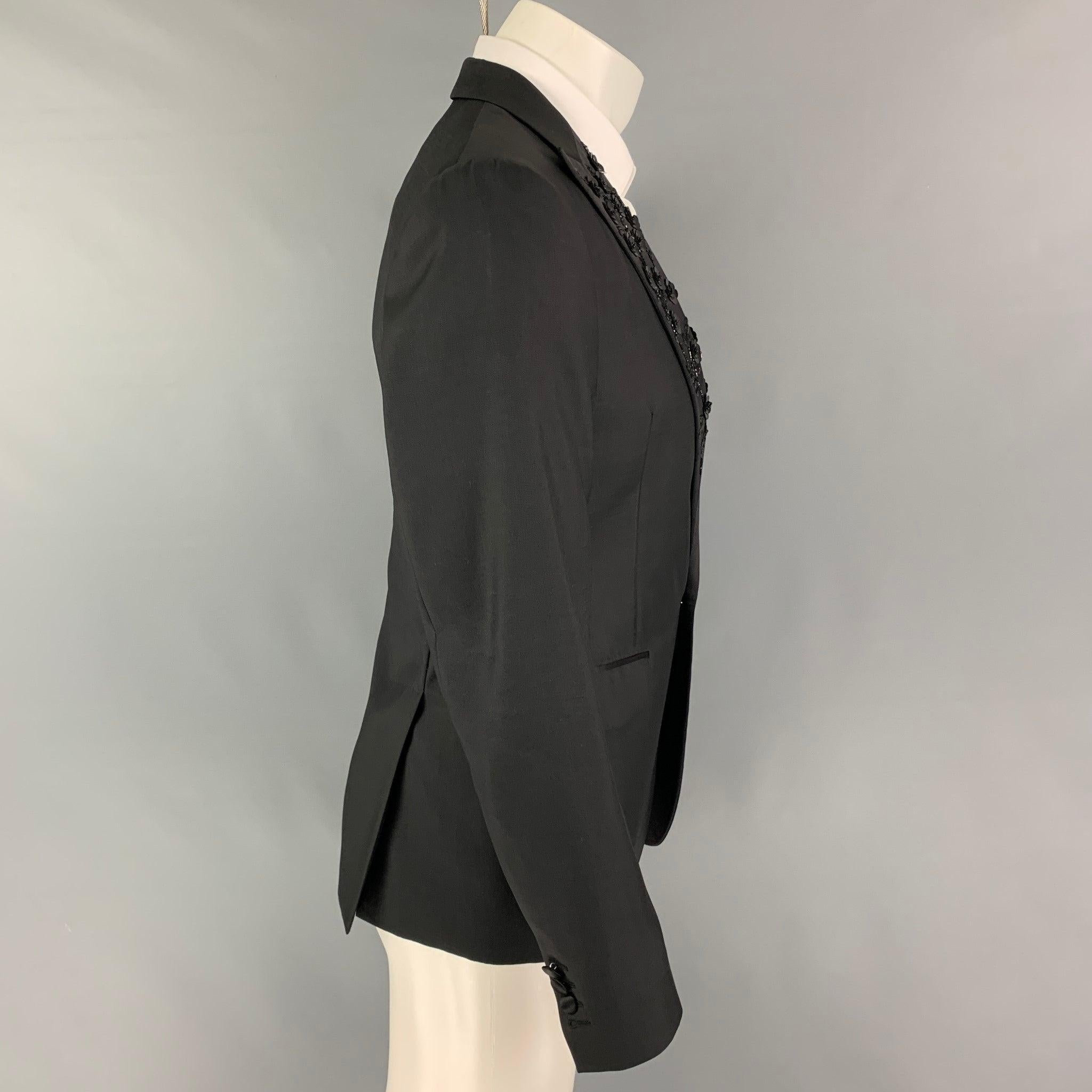 DSQUARED2 sport coat comes in a black wool / silk with a full liner featuring a floral sequined peak lapel, flap pockets,double back vent, anda single button closure. Made in Italy.
Excellent
Pre-Owned Condition. 

Marked:   48 

Measurements: 
