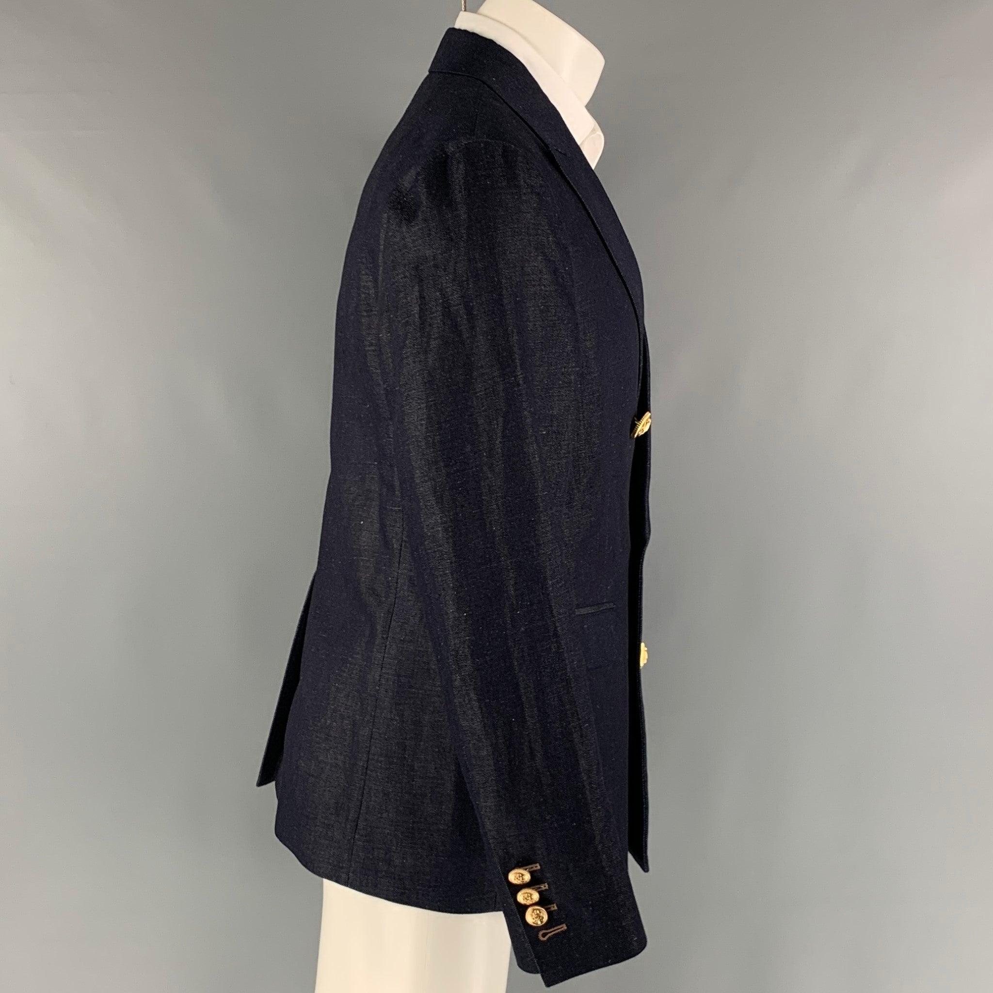 DSQUARED2 sport coat comes in an indigo cotton and linen twill material with a half liner featuring a peak lapel, single back vent, flap pockets, gold tone buttons, and a double breasted closure. Made in Italy. Excellent Pre- Owned Material.