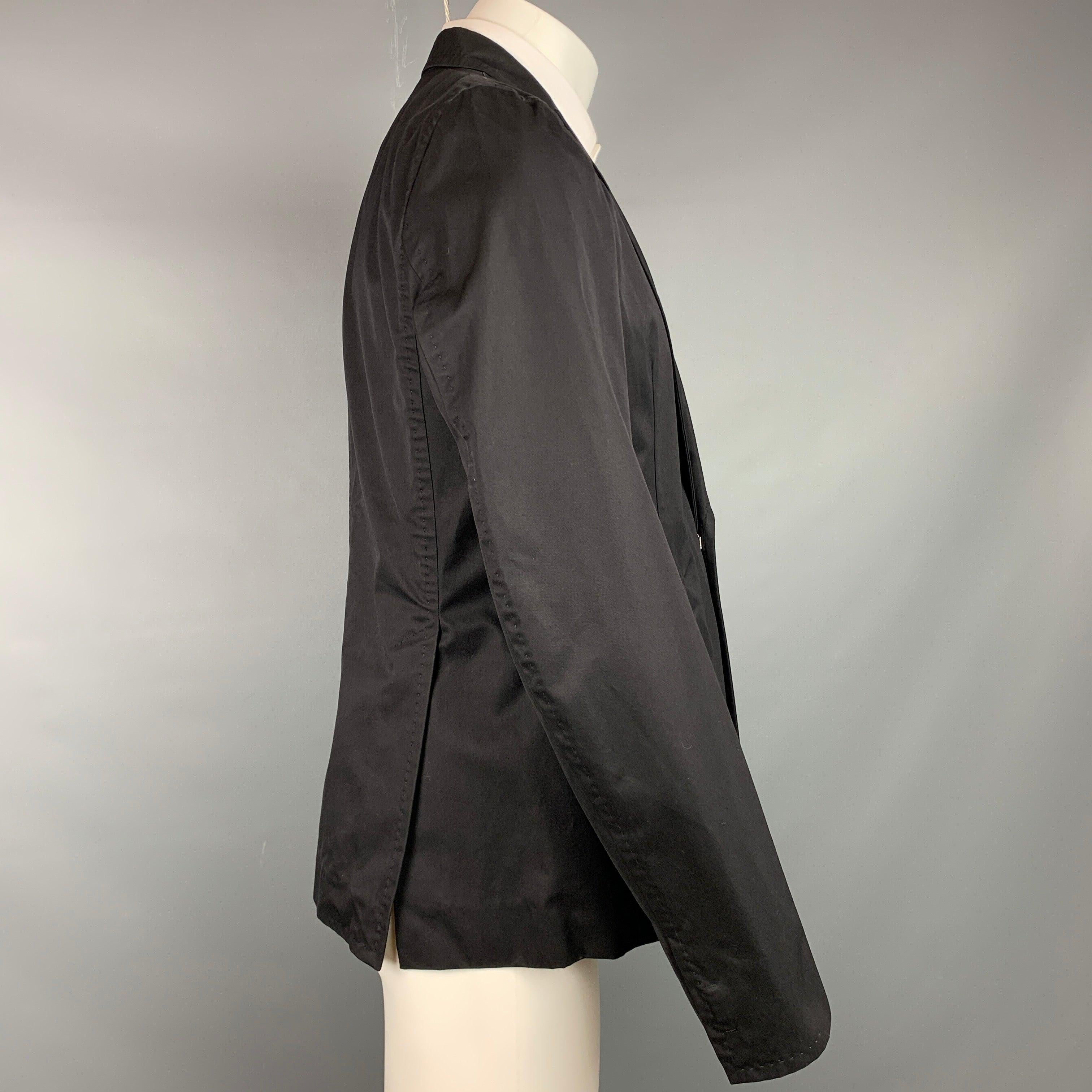 DSQUARED2 sport coat in a black cotton with a half pink monogram liner featuring a peak lapel, flap pockets, and a hook & eye closure. Made in Italy.Very Good Pre-Owned Condition. 

Marked:   IT 50 

Measurements: 
 
Shoulder: 16.5 inches  Chest: 40
