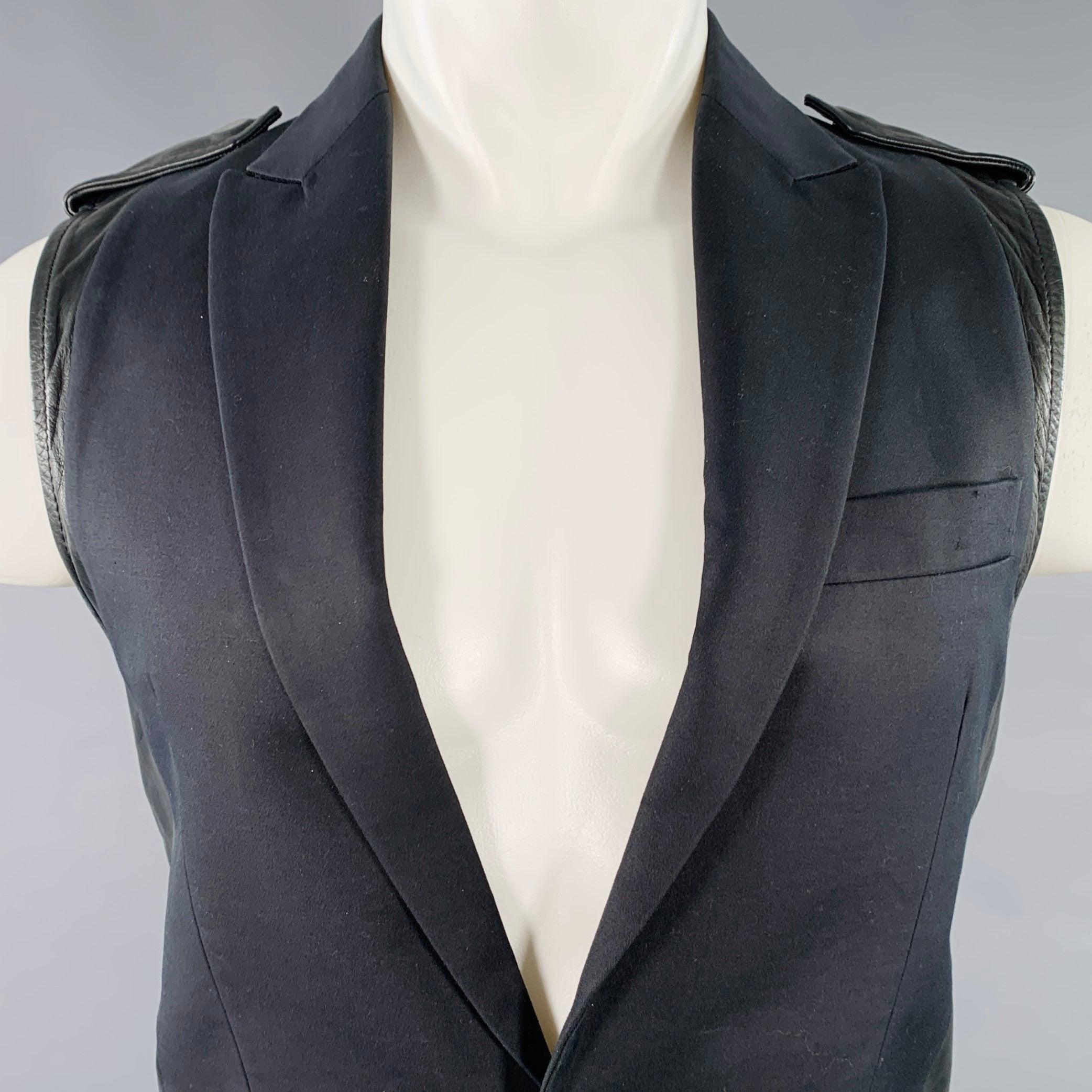 DSQUARED2 vest
in a black cotton silk blend featuring a peak lapel, leather back with motorcycle-style belt, and single button closure. Very Good Pre-Owned Condition. Minor signs of wear. 

Marked:   IT 50 

Measurements: 
 
Shoulder: 15 inches