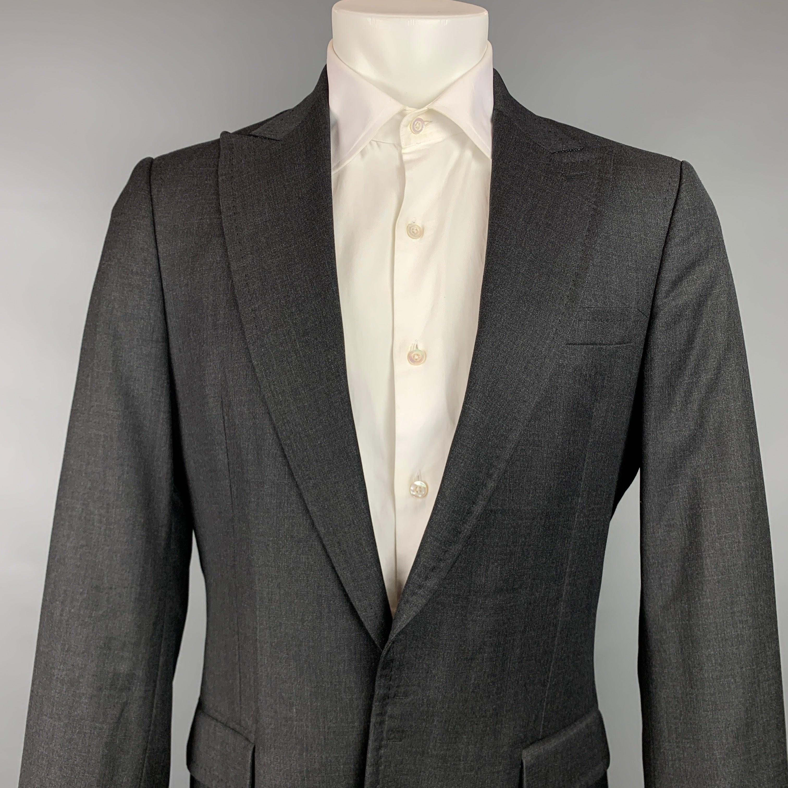 DSQUARED2
sport coat comes in a charcoal wool with a full liner featuring a peak lapel, flap pockets, and a hook & eye closure. Made in Italy.Very Good Pre-Owned Condition. 

Marked:   50 

Measurements: 
 
Shoulder: 17.5 inches  Chest: 40 inches 
