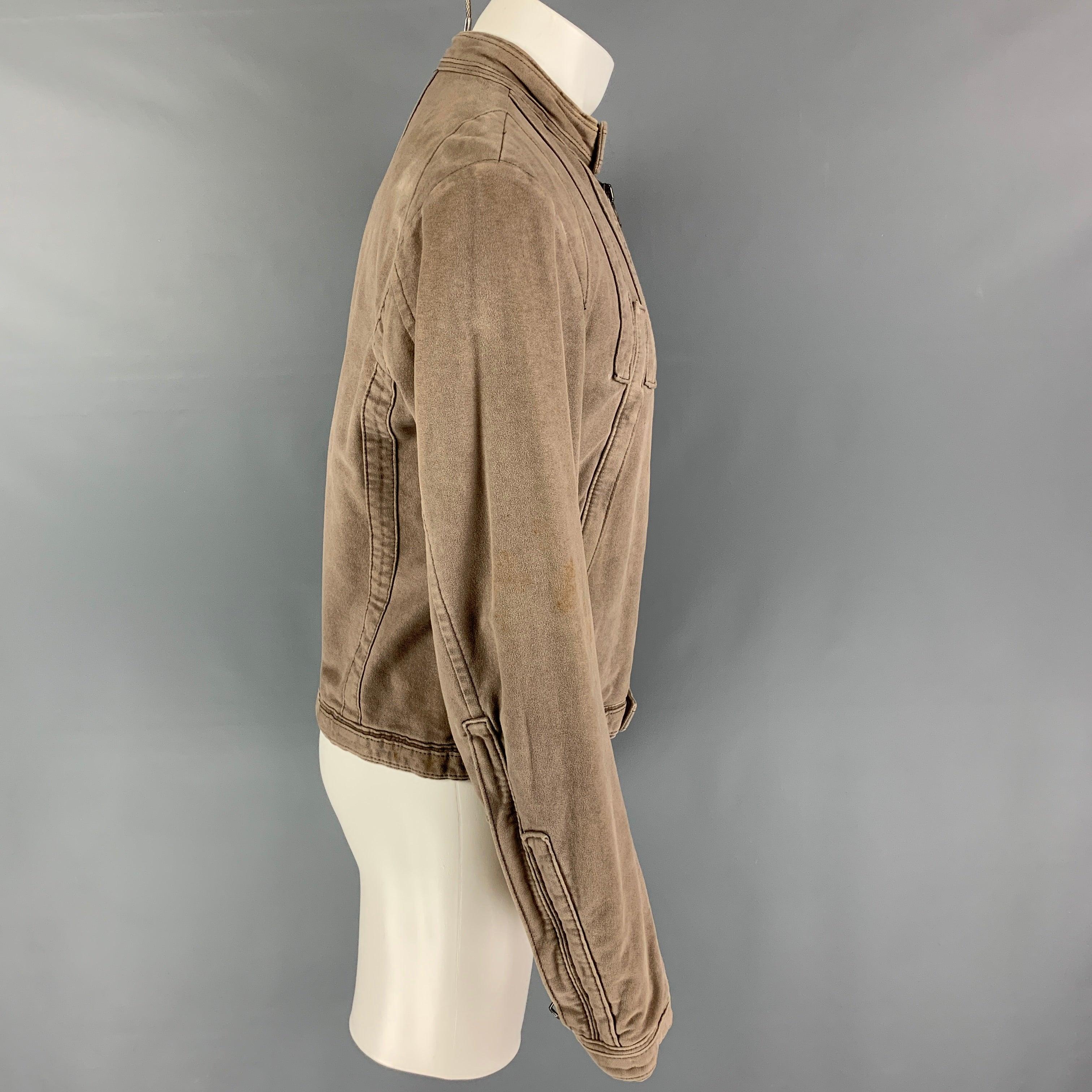DSQUARED2 jacket comes in a taupe moleskin featuring a snap button collar, top stitching, zipper pockets, zipped sleeves, and a full zipper closure. Made in Italy.
Good
Pre-Owned Condition. Moderate discoloration. As-is.  

Marked:   50