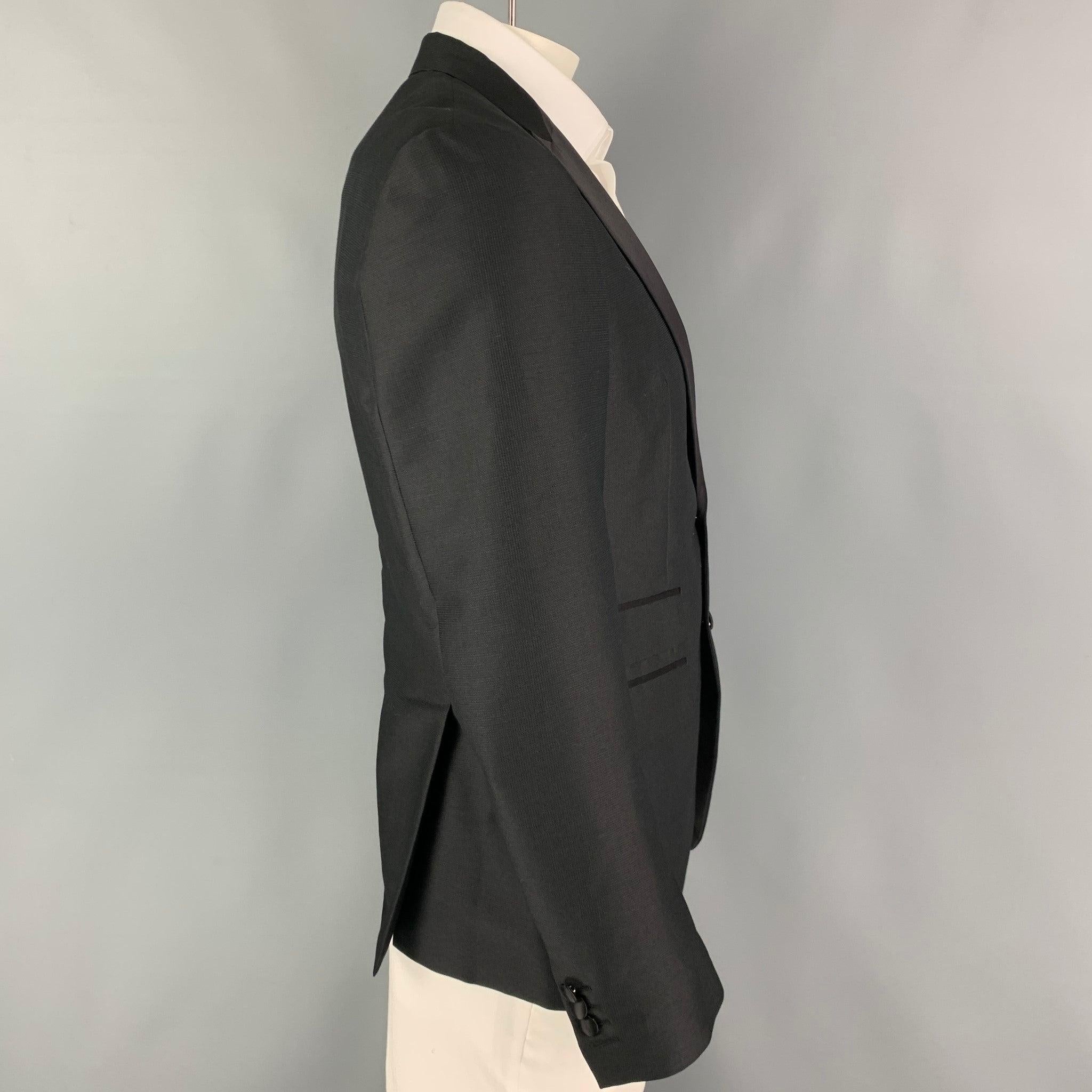 DSQUARED2 sport coat comes in a black nailhead mohair blend with a half liner featuring a peak lapel, flap pockets, double back vent, and a double button closure. Made in Italy.
Excellent
Pre-Owned Condition. 

Marked:   52 

Measurements: 
