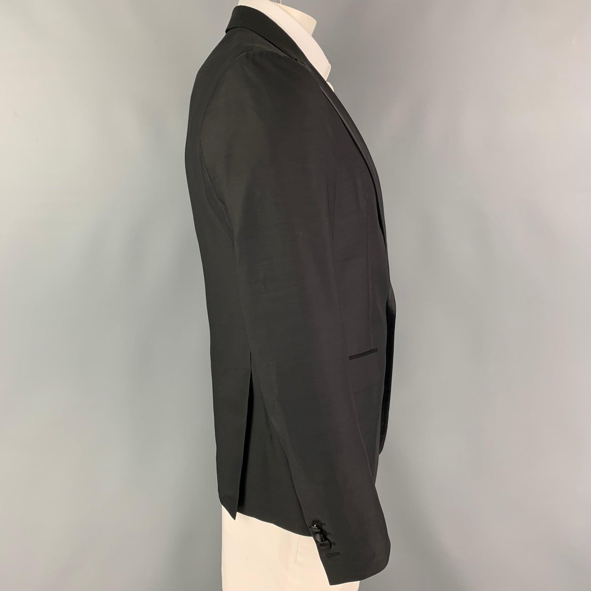 DSQUARED2 sport coat comes in a black wool / silk with a half liner featuring a peak lapel, flap pockets, double back vent, and a double button closure. Made in Italy.
Excellent
Pre-Owned Condition. 

Marked:   52 

Measurements: 
 
Shoulder: 18