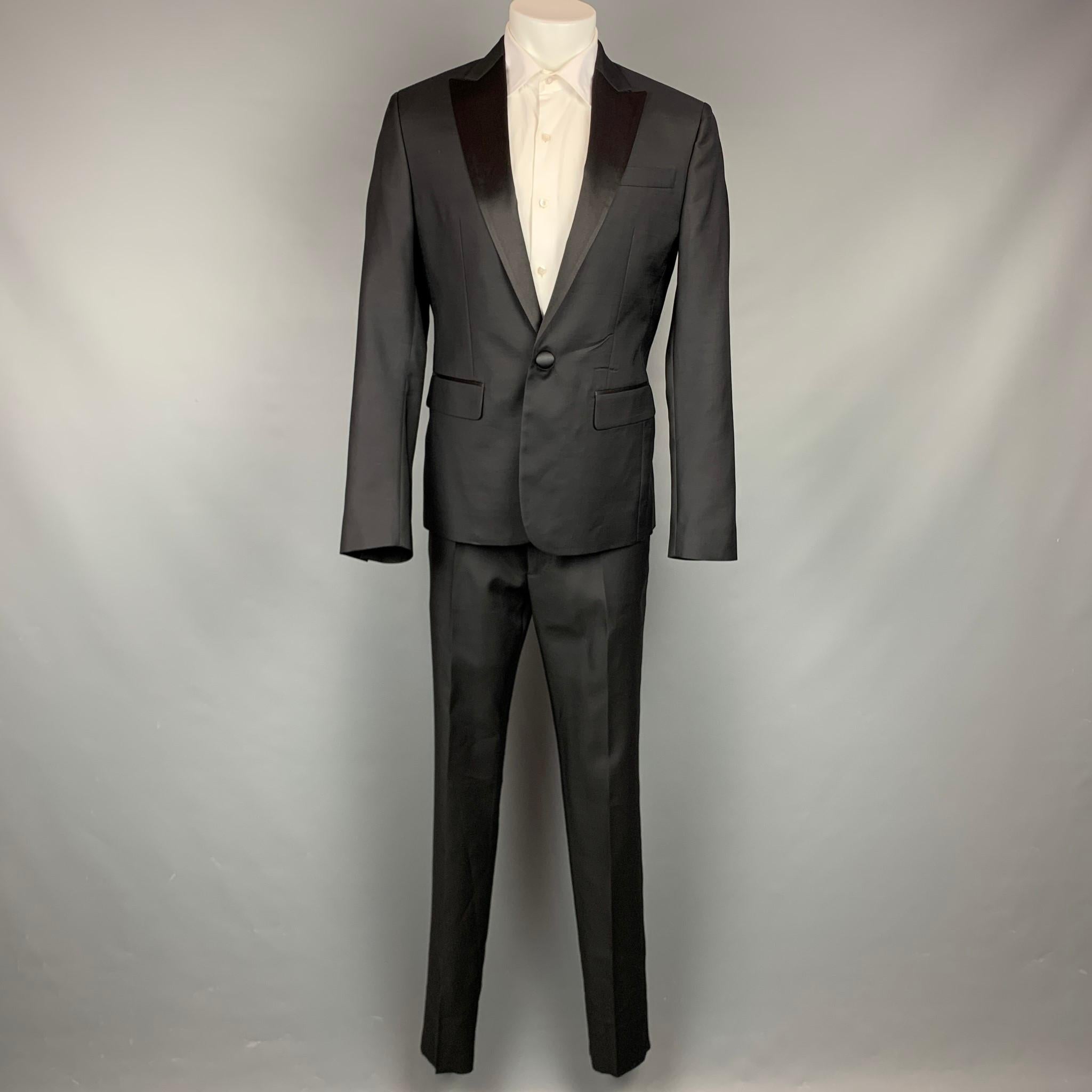DSQUARED2 suit comes in a black wool / silk with a full liner and includes a single breasted, single button sport coat with a peak lapel and matching flat front trousers. Made in Italy.

Excellent Pre-Owned Condition.
Marked: Jacket: IT 52
Pants: