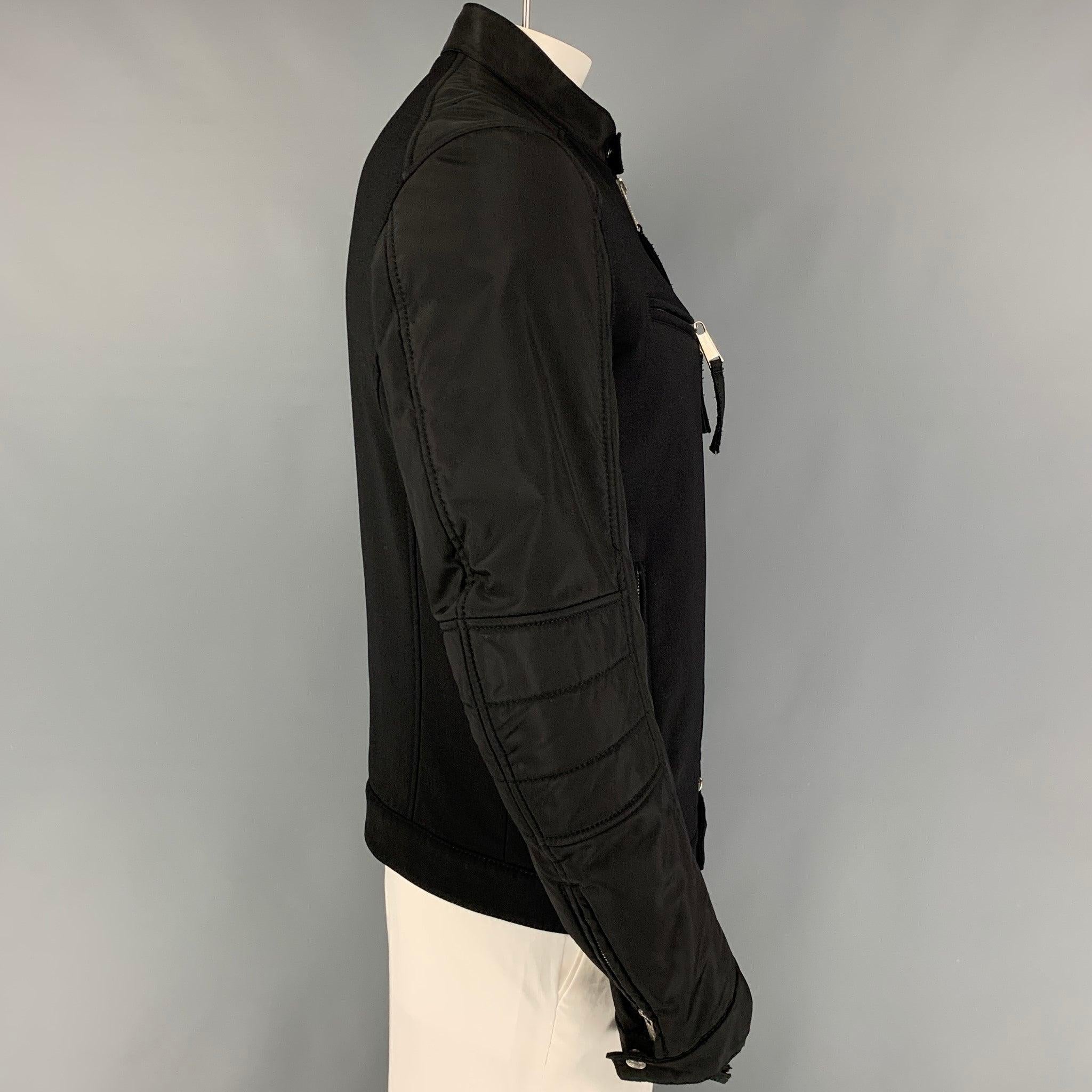 DSQUARED2 jacket comes in a black wool blend featuring a biker style, collarless, zipped sleeves, padded elbows, zipper pockets, and a full zip up closure. Made in Italy.
Good
Pre-Owned Condition. Moderate discoloration at interior.  

Marked:   54