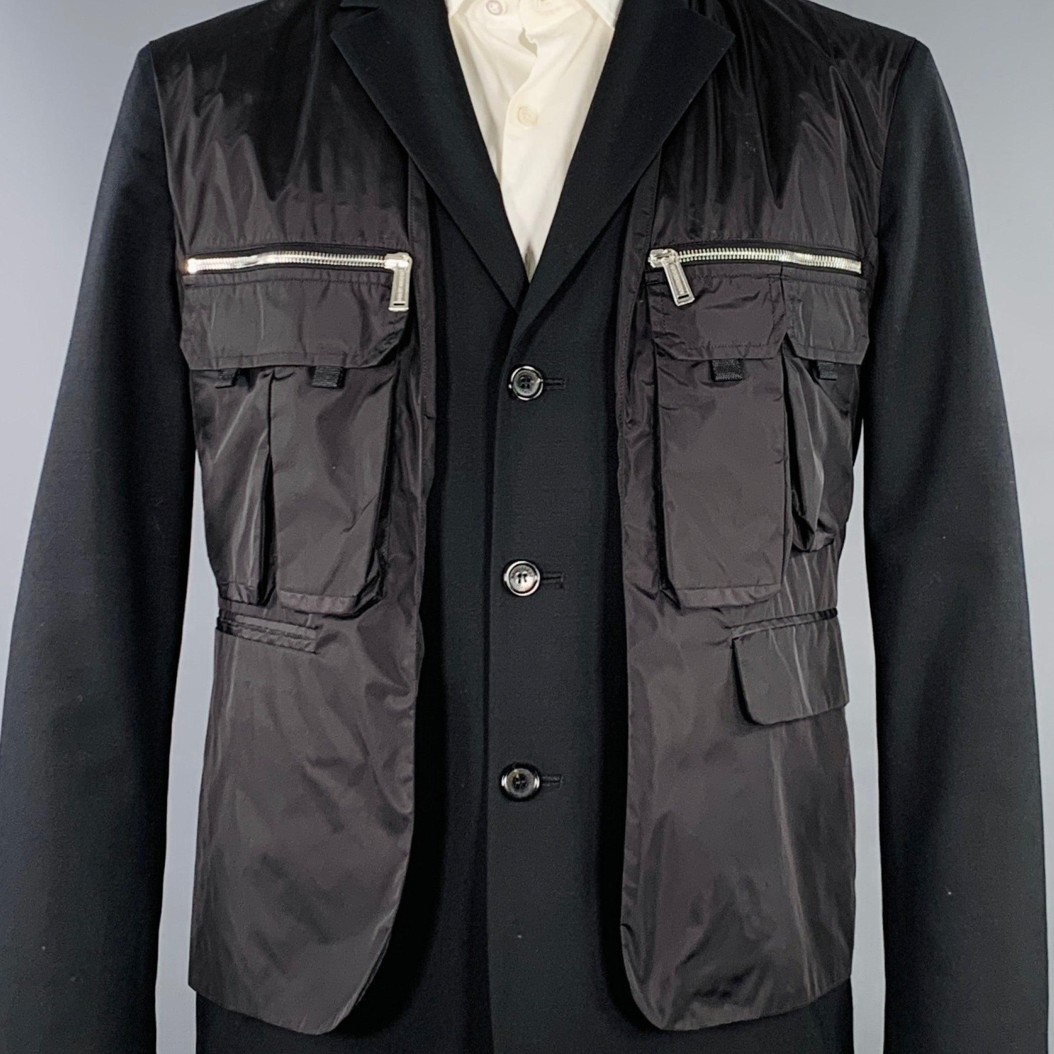DSQUARED2 sport coat
in a black virgin wool blend fabric featuring attached utility vest with silver tone metal zippers,
 notch lapel, single vented back, and three button closure. Made in Italy.Very Good Pre-Owned Condition. Minor mark on sleeve.