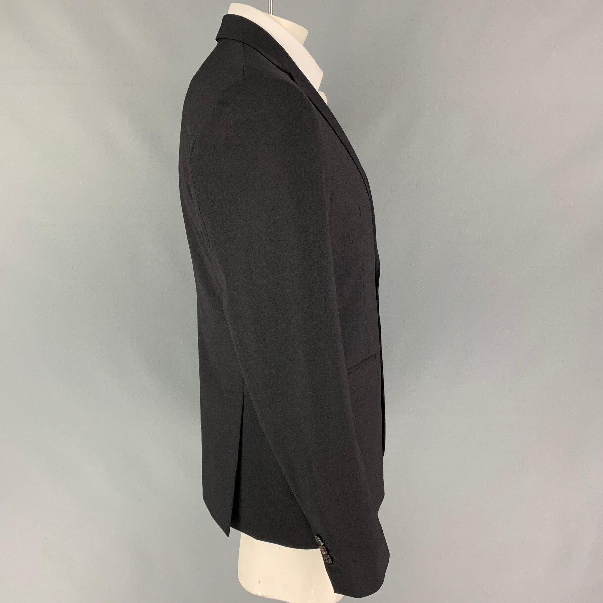 DSQUARED2 sport coat comes in a black wool with a full liner featuring a notch lapel, flap pockets, double back vent, and a double button closure. Made in Italy.
Very Good
Pre-Owned Condition. 

Marked:   54 

Measurements: 
 
Shoulder: 18.5 inches 