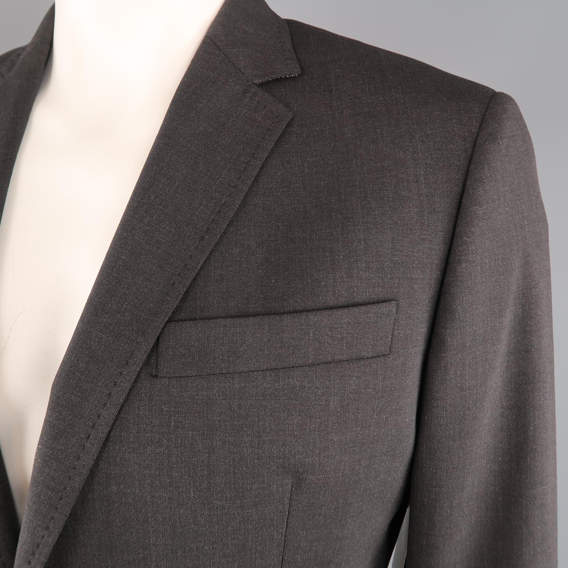 DSQUARED2 sport coat comes in Charcoal wool blend fabric with a notch lapel, single breasted, two  button front, and top stitching. Made in Italy.
 
Excellent Pre-Owned Condition.
Marked: IT 54
 
Measurements:
 
Shoulder: 19 in.
Chest: 44