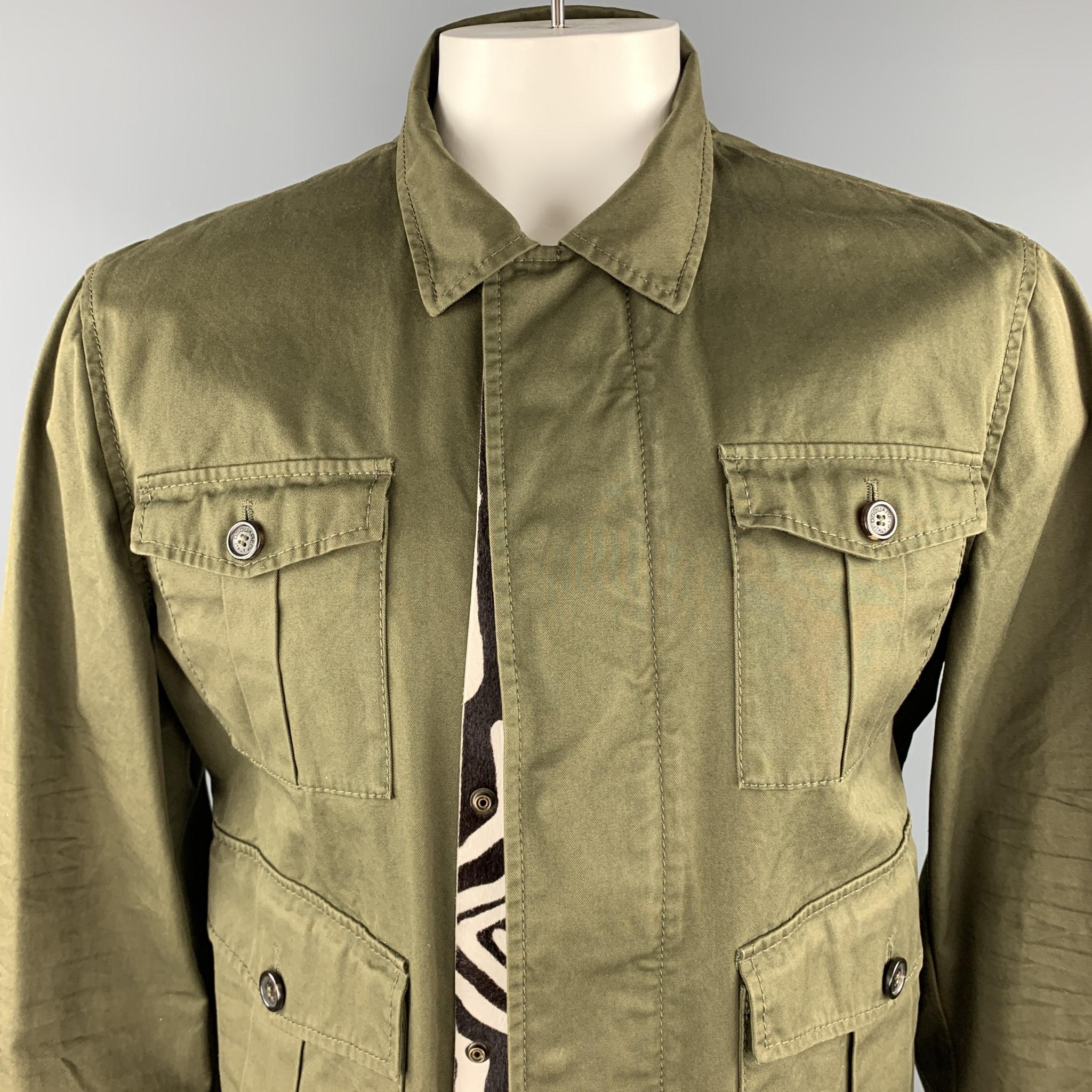 DSQUARED2 army style jacket comes in olive cotton with patch flap pockets, raw frayed hem, and zip front with zebra pony hair leather trimmed snap placket. Made in Italy.

Excellent Pre-Owned Condition.
Marked: IT 54

Measurements:

Shoulder: 19