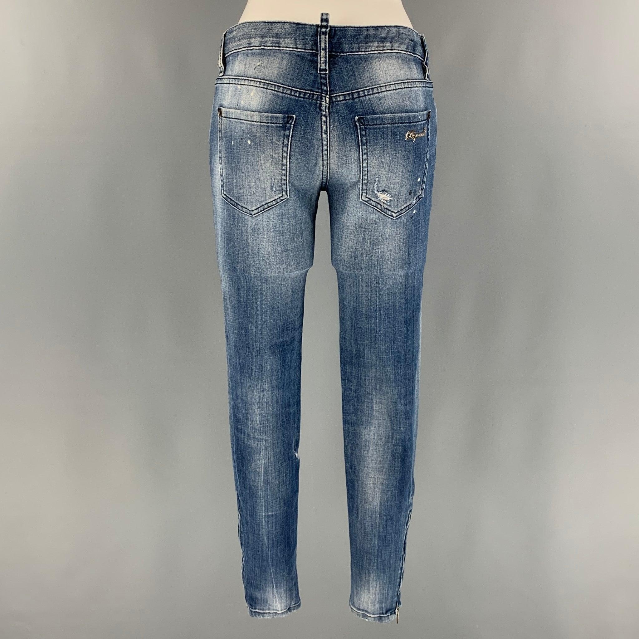 DSQUARED2 skinny jeans comes in a blue cotton and elastane denim featuring a low rise, paint splatter details, and a zipper fly closure. Made in Italy.Very Good Pre- Conditions. 

Marked:   42 

Measurements: 
  Waist: 30 inches Rise: 7 inches