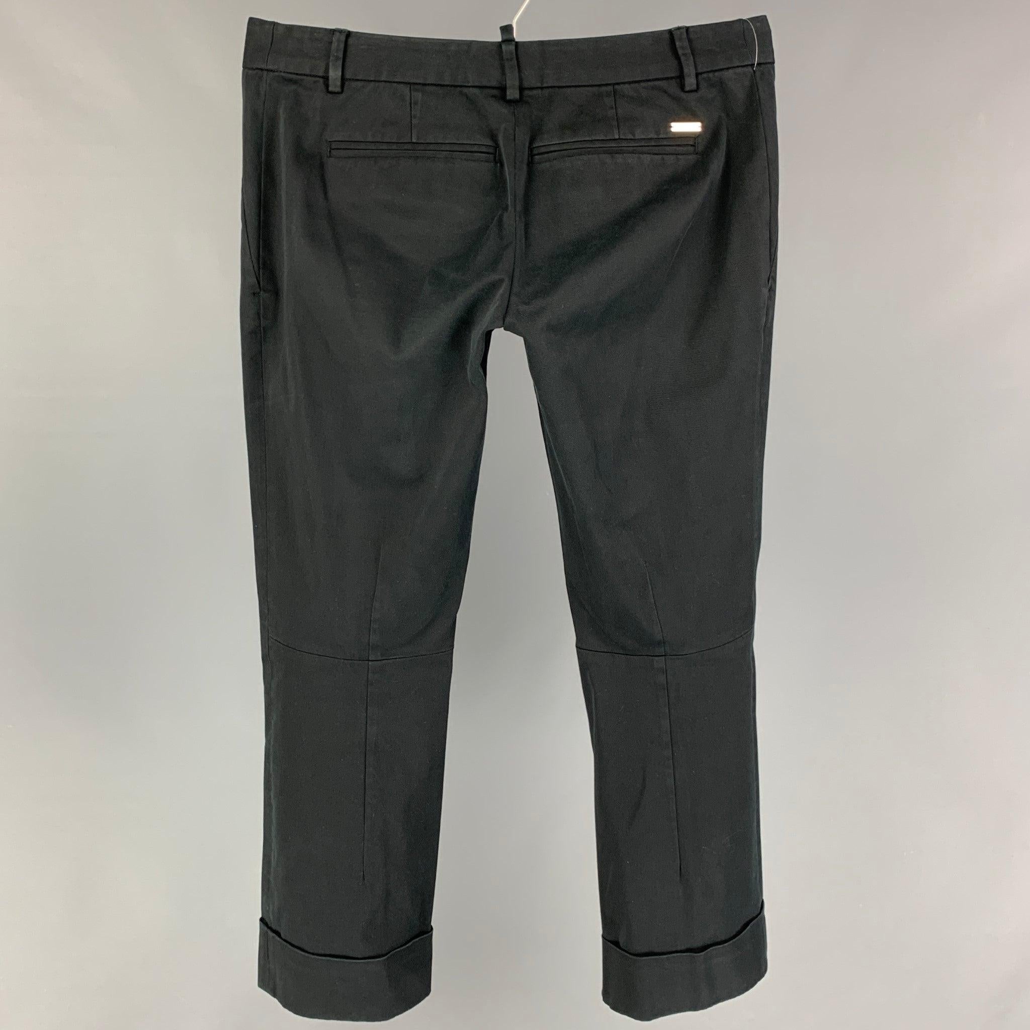 DSQUARED2 pants comes black cotton featuring a cropped style, front tab, and a buttoned fly. Made in Italy.
Very Good
Pre-Owned Condition. 

Marked:   44 

Measurements: 
  Waist: 32 inches  Rise: 7 inches  Inseam: 27 inches 
  
  
 
Reference: