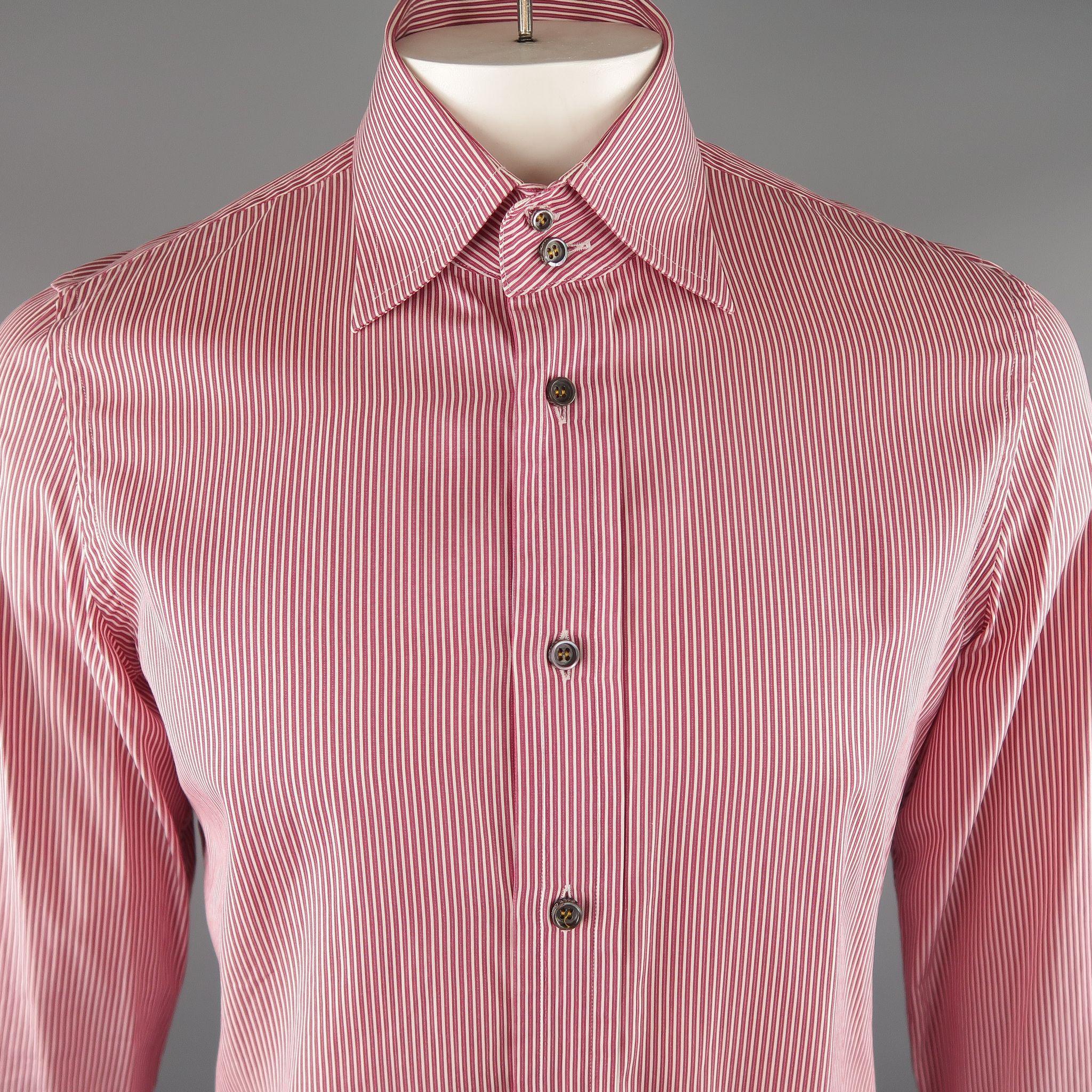 DSQUARED2 Long Sleeve Shirt comes in red and white tones, in a pinstripe cotton material, with a double closure at the spread collar, button up and with a wide cuff. Minor wear, one of the buttons at left cuff is partially broken. Made in Italy.
