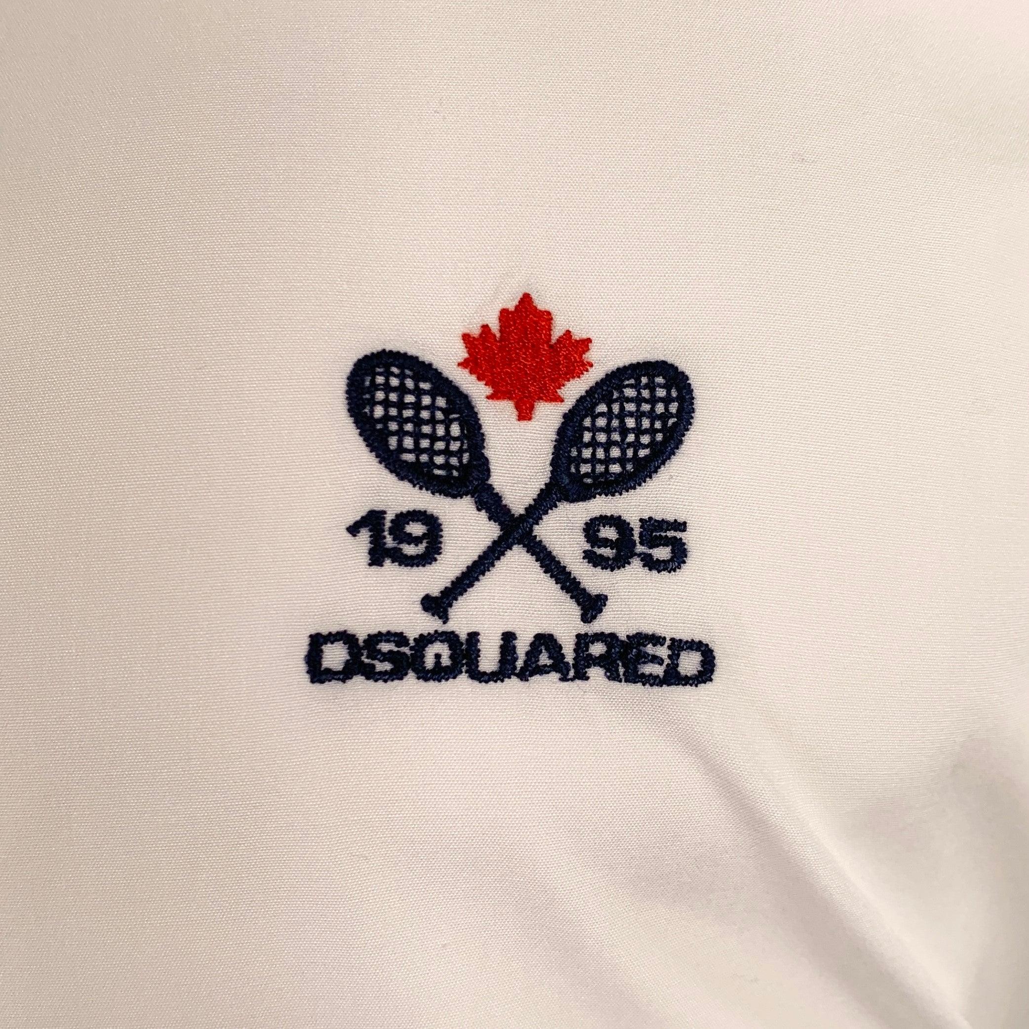 DSQUARED2 short sleeve shirt
in a white cotton woven fabric featuring DSQUARED2 embroidered logo with rackets, spread collar, and button closure. Made in Italy.Very Good Pre-Owned Condition. Minor mark on right shoulder. 

Marked:   IT 48