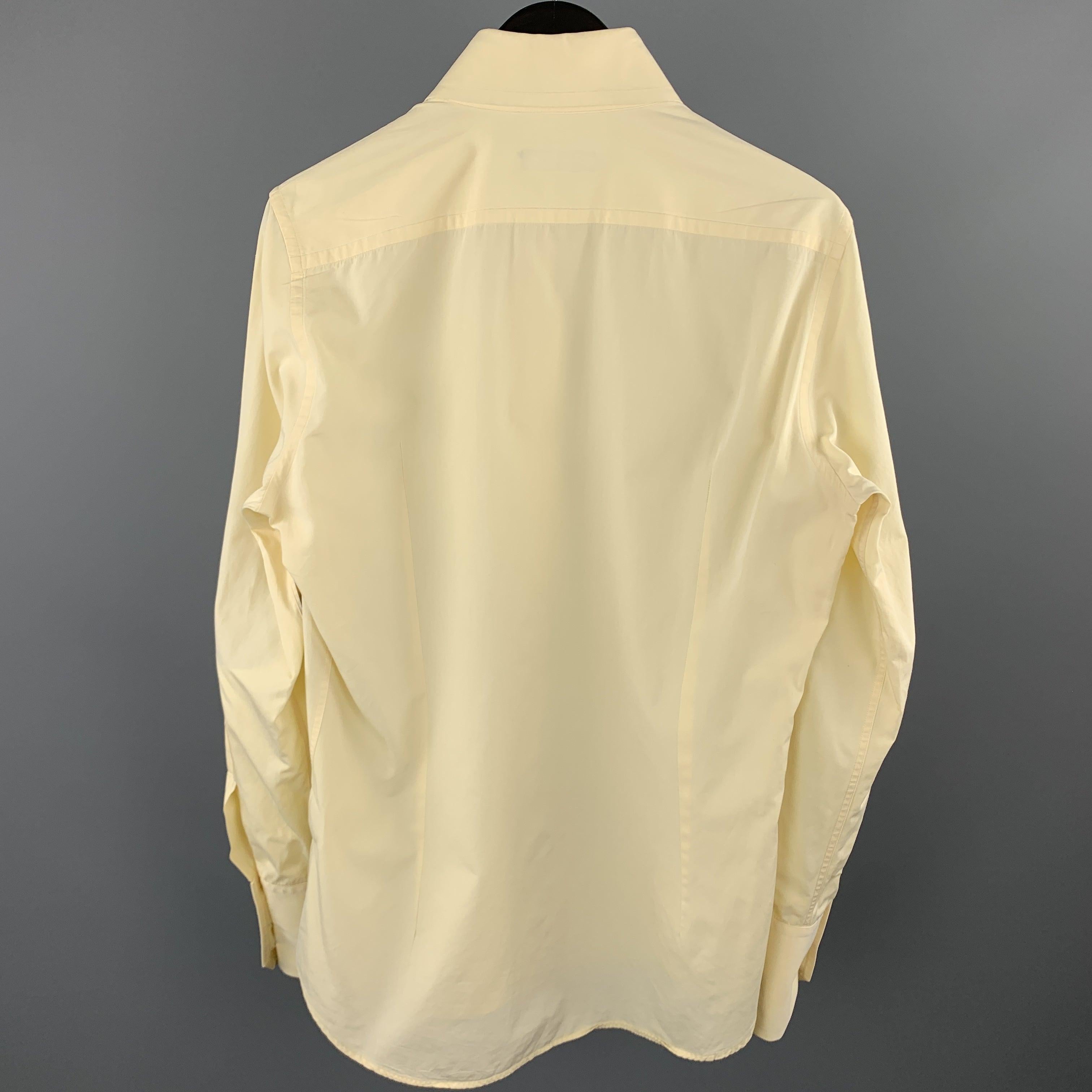 DSQUARED2 long sleeve shirt comes in a yellow cotton featuring a button up style and a spread collar. Made in Italy.Excellent
Pre-Owned Condition. 

Marked:   IT 48 

Measurements: 
 
Shoulder: 16 inches Chest: 41 inches 
Sleeve: 27.5 inches