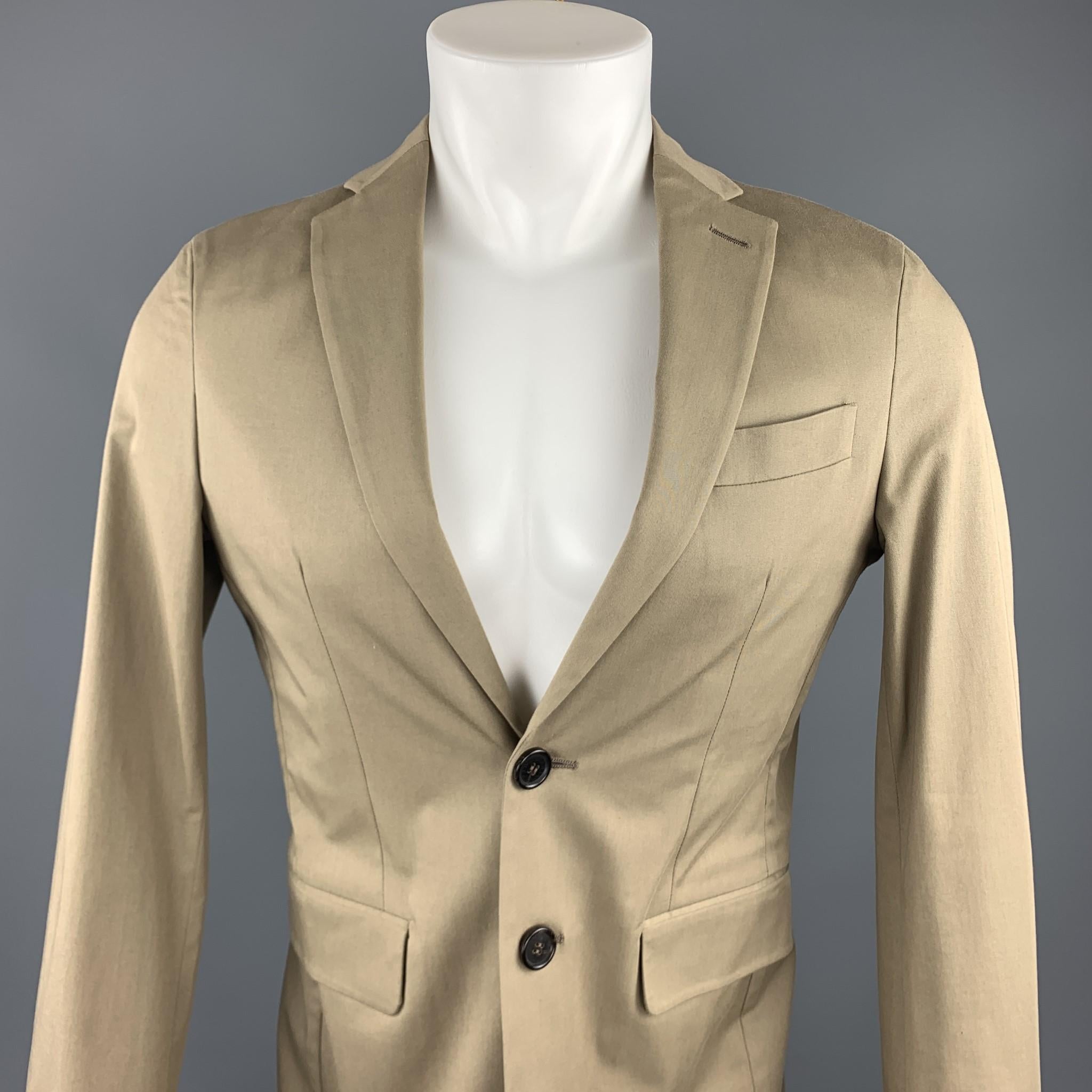 DSQUARED2 sport coat comes in a taupe cotton blend featuring a notch lapel style, flap pockets, and a two button closure. Made in Italy.

Excellent Pre-Owned Condition.
Marked: IT 46

Measurements:

Shoulder: 17 in. 
Chest: 38 in. 
Sleeve: 25 in.