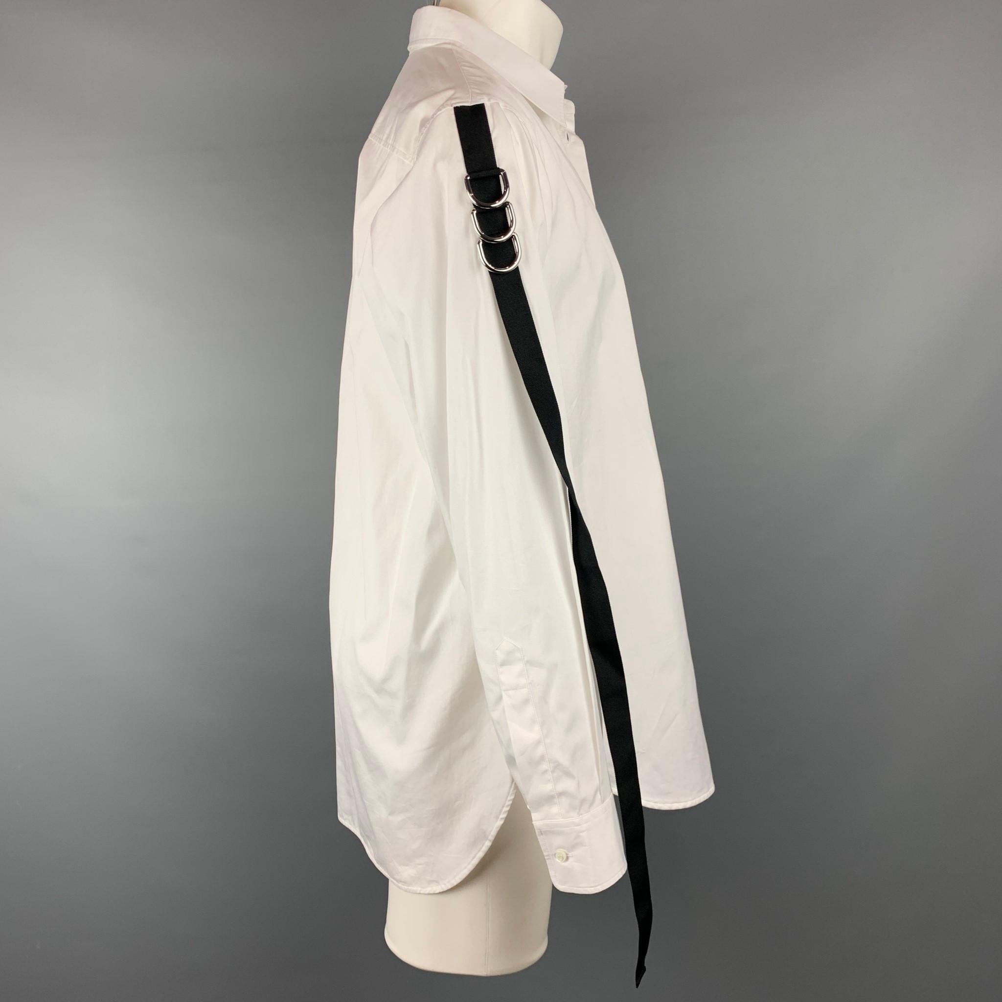DSQUARED2 long sleeve shirt comes in a white cotton with a black ribbon trim with hoop details featuring a button up style and a spread collar. Made in Romania.

Very Good Pre-Owned Condition.
Marked: 46

Measurements:

Shoulder: 19.5 in.
Chest: 46