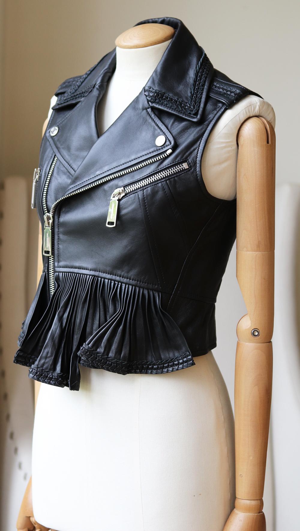 DSquared2's sleeveless leather biker jacket is a perfect layering piece - the slim peplum-fit makes it easy to slip over everything from sleek dresses to knitwear. 
Black leather. 
Snap-fastening epaulettes and pleated peplum waist, two front zip