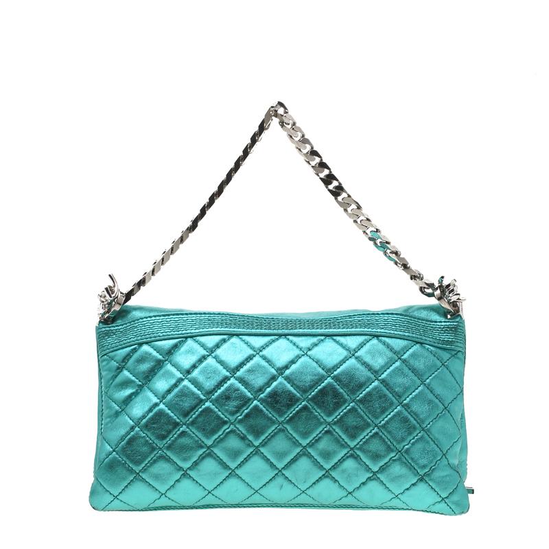 This clutch by Dsquared2 is one you will love carrying around. It is edgy, captivating, and stylish. The clutch is made from metallic teal leather and it features zipper details, a flap pocket, and a folded top that reveals a canvas interior. It is
