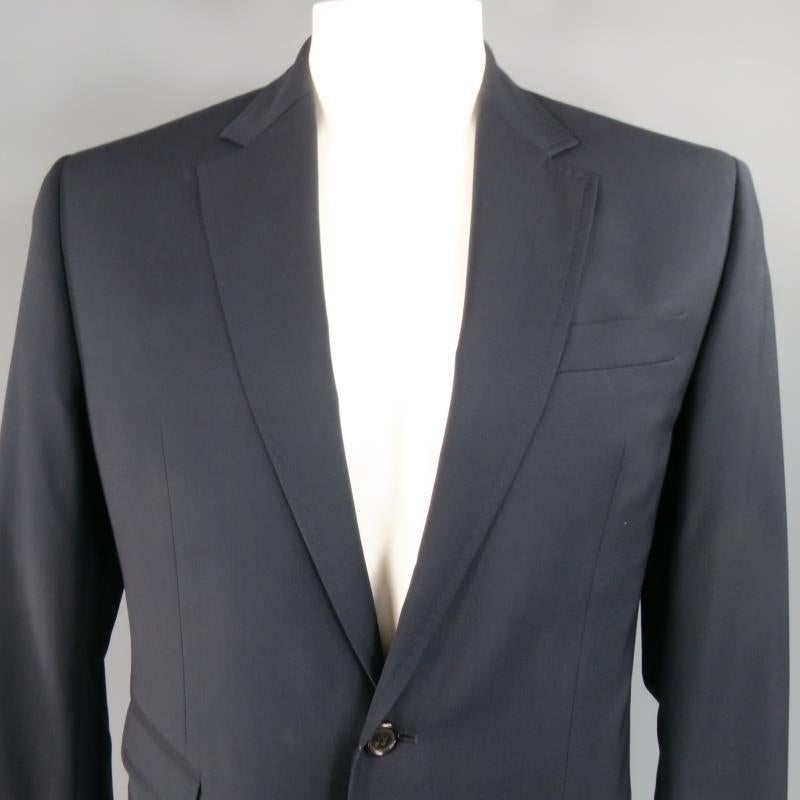 DSQUARED2 Sport Coat consists of wool material in a navy color tone. Designed in a 2-button front, classic notch lapel collar with tone-on-tone stitching. Detailed with chest pocket, bottom flap pockets and 3-button cuffs. Single back vent and full