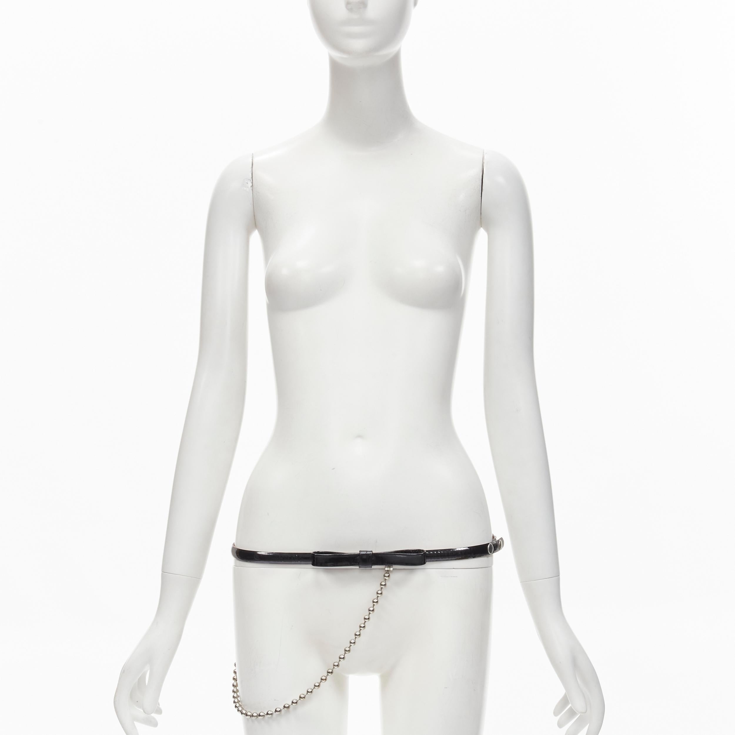DSQUARED2 Vintage black patent leather bow silver ball chain belt S
Brand: Dsquared2
Material: Patent Leather
Color: Black
Pattern: Solid
Closure: Snap Buttons
Extra Detail: Attached ball chain
Made in: Italy

CONDITION:
Condition: Very good, this