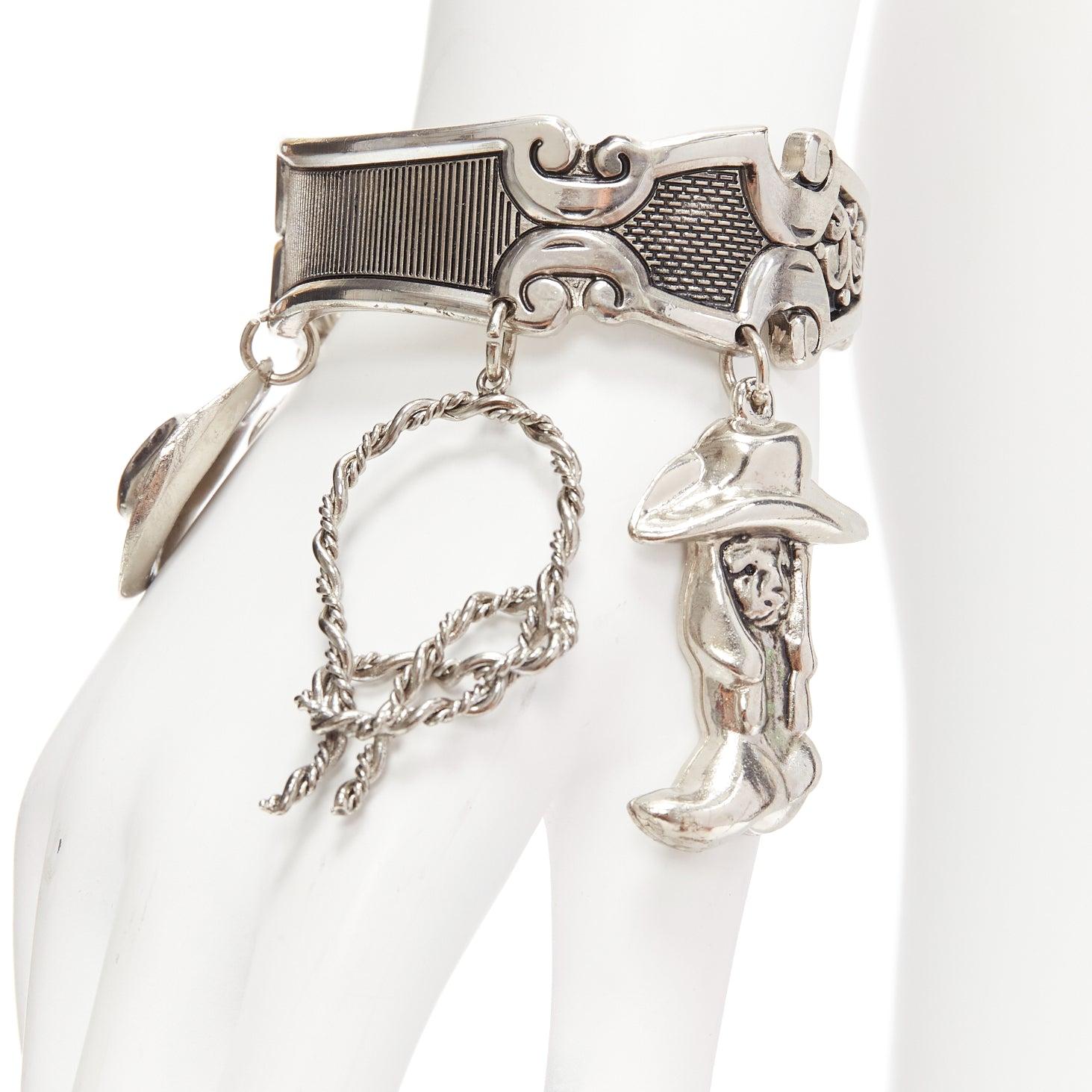 DSQUARED2 Vintage silver metal Western Cowboy charm cuff bangle
Reference: ANWU/A01079
Brand: Dsquared2
Material: Metal
Color: Silver
Pattern: Solid
Lining: Silver Metal
Extra Details: Cowboy boot, loop, hat and seam baroque motive details.
Made in: