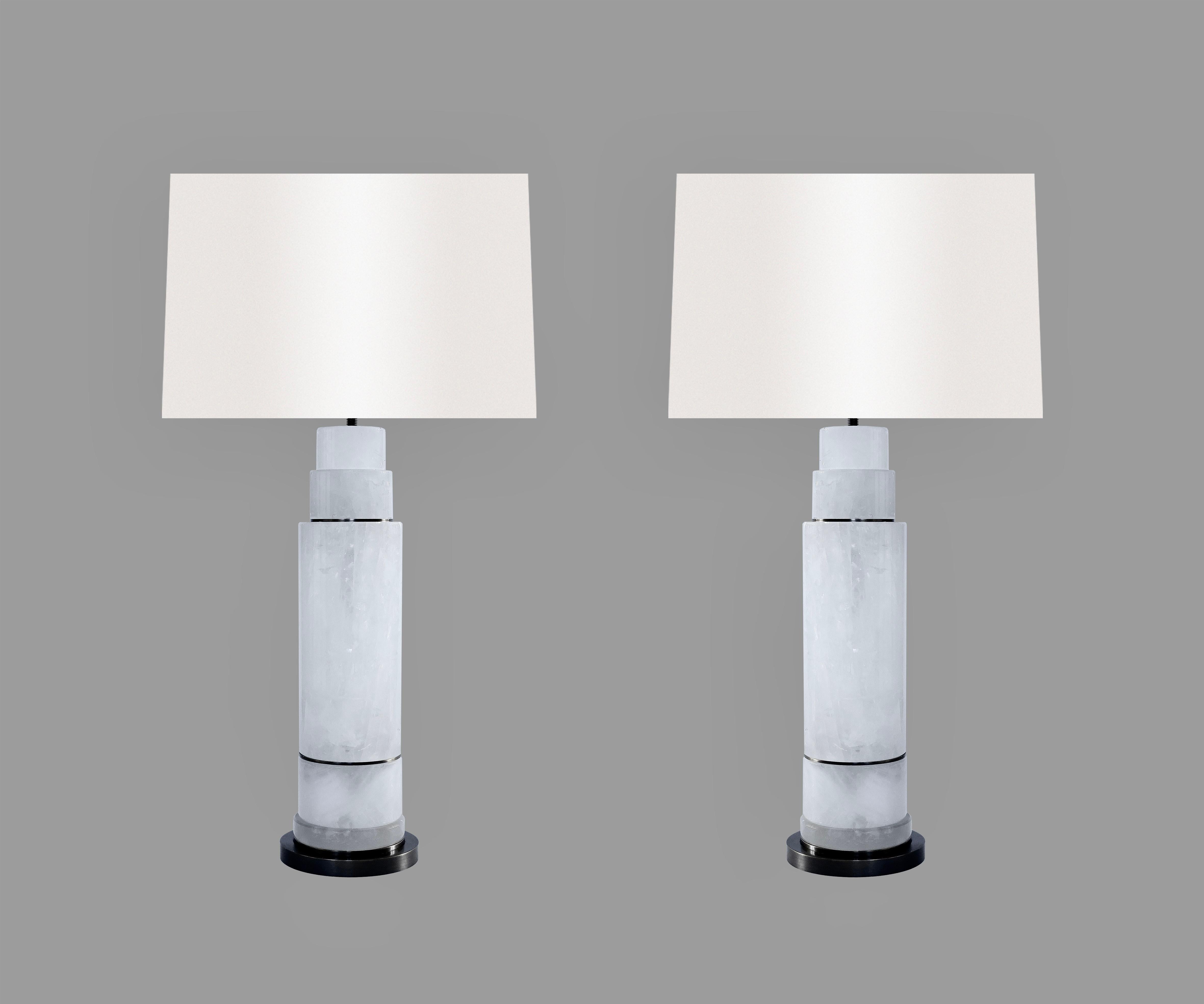 Pair of sectional column rock crystal lamps with aged brass inserts and bases. Created by Phoenix Gallery, NYC.
To the top of rock crystal: 14.75”
(Lampshade not included.)