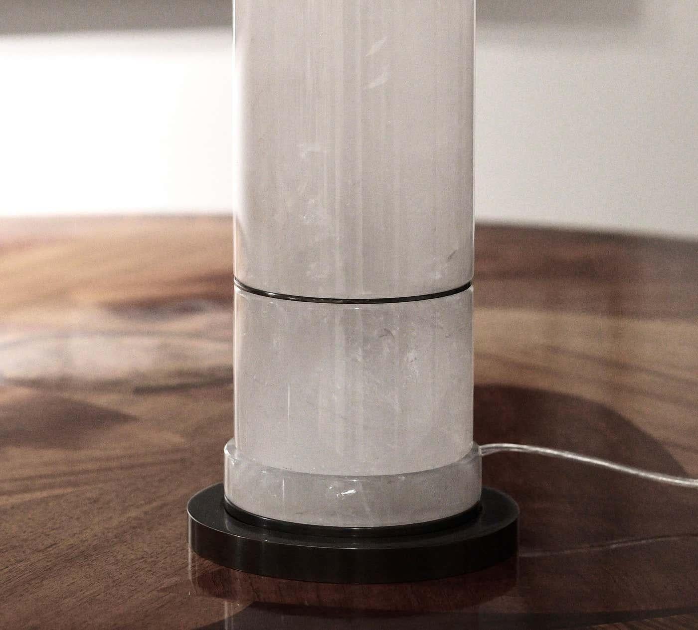 Sectional column rock crystal lamp with aged brass inserts and base. Created by Phoenix Gallery, NYC. To the top of rock crystal: 17”/H (Lampshade not included.)