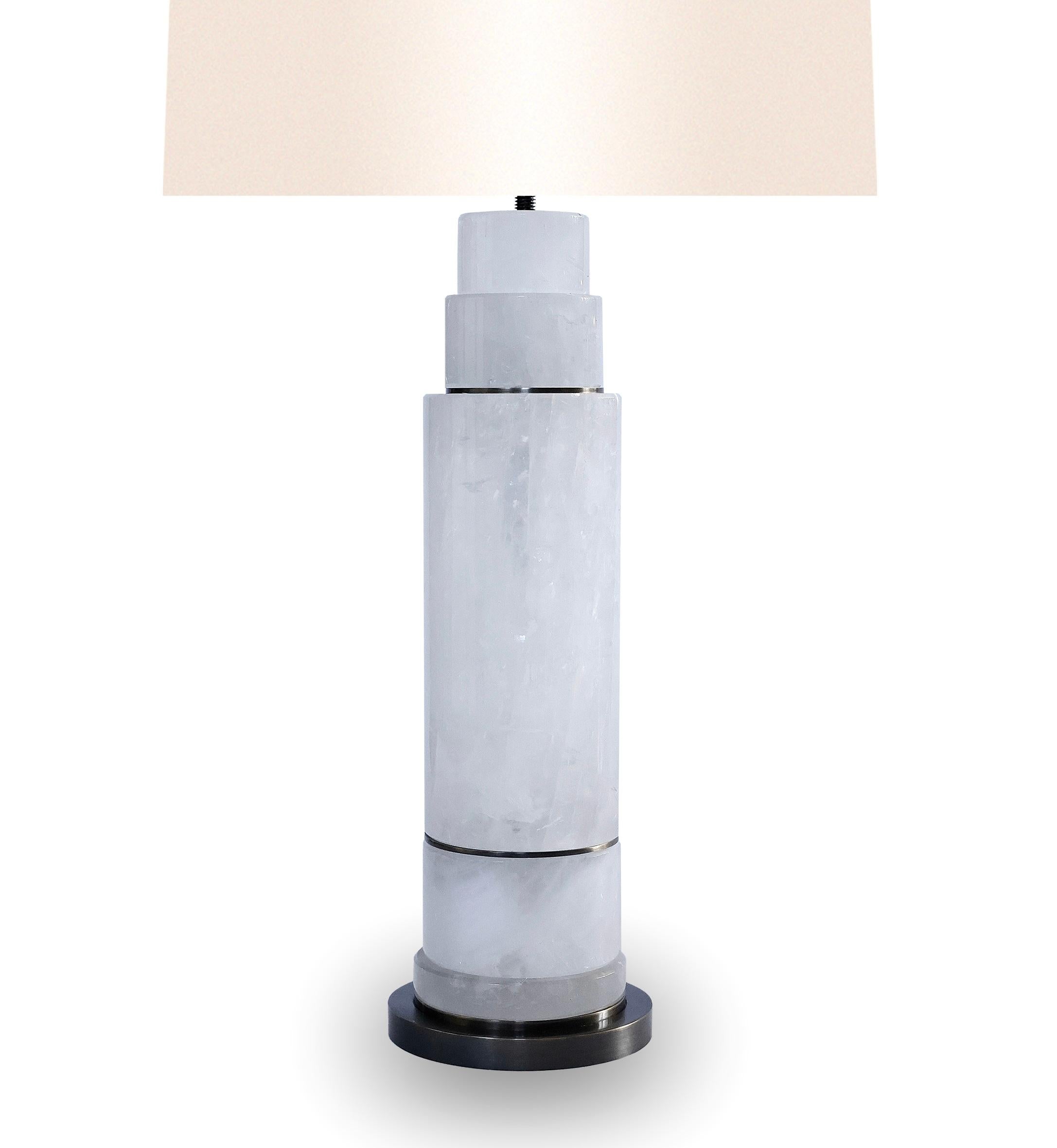 Pair of sectional column rock crystal lamps with aged 
brass inserts and bases. Created by Phoenix Gallery, NYC.
To the top of rock crystal: 17”/H
(Lampshade not included.)