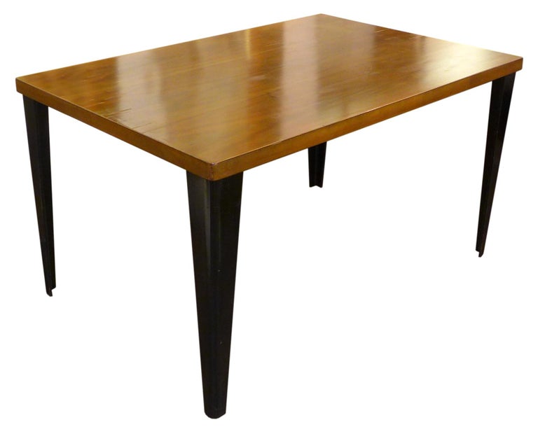 A wonderful, rare DTW-1 table by Charles Eames for Herman Miller. Built as a companion piece to the Eames plywood dining chairs, a solid, rectangular, walnut-veneer slab sits atop contrasting, black-aniline-dyed, right-angle-bent and tapering