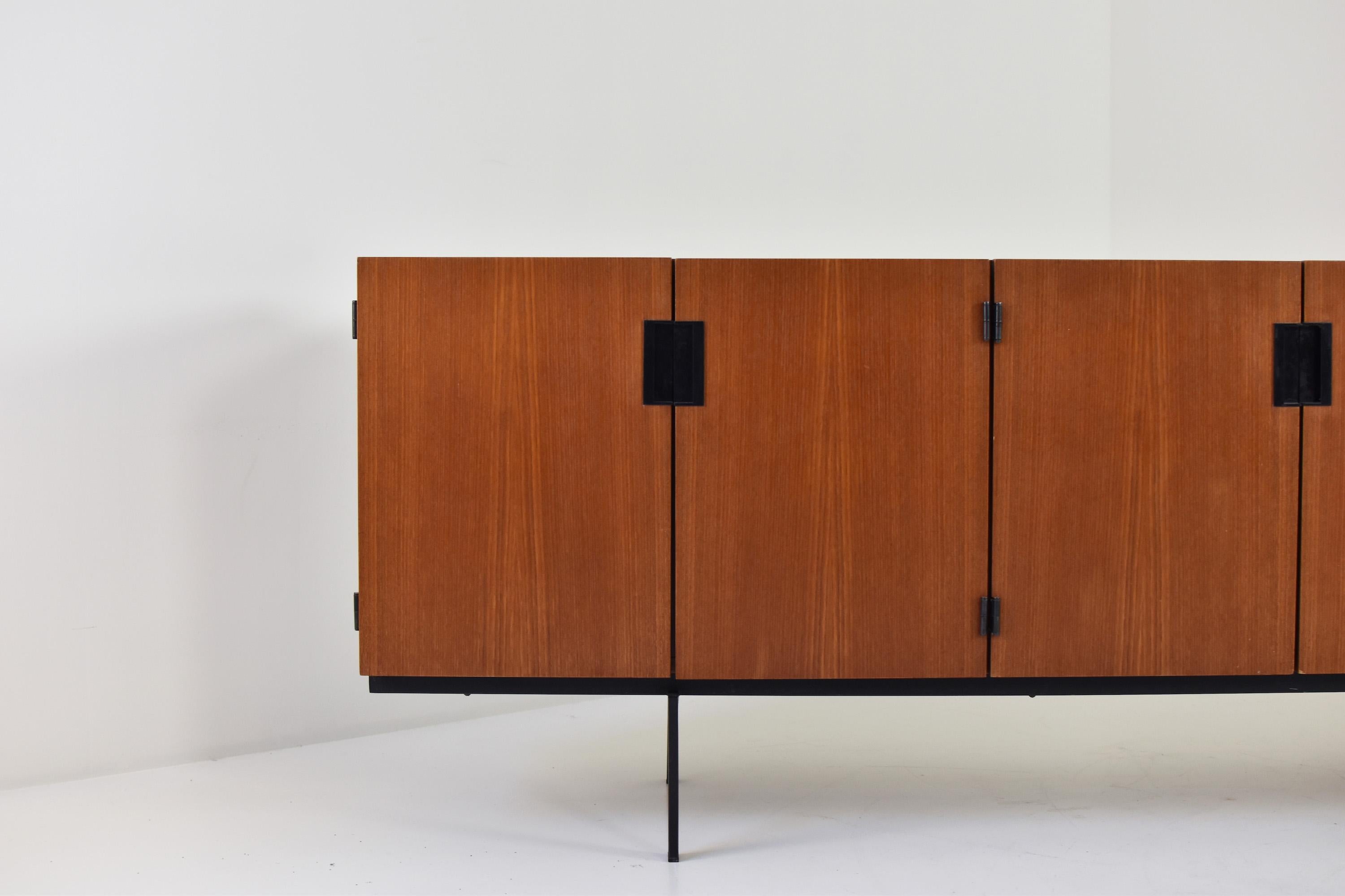 Sideboard, Model DU03, by Cees Braakman for UMS Pastoe, The Netherlands 1958. This sideboard is made out of teak and features black rectangular handles and a black lacquered metal frame. On the left two storage compartments with shelves, on the