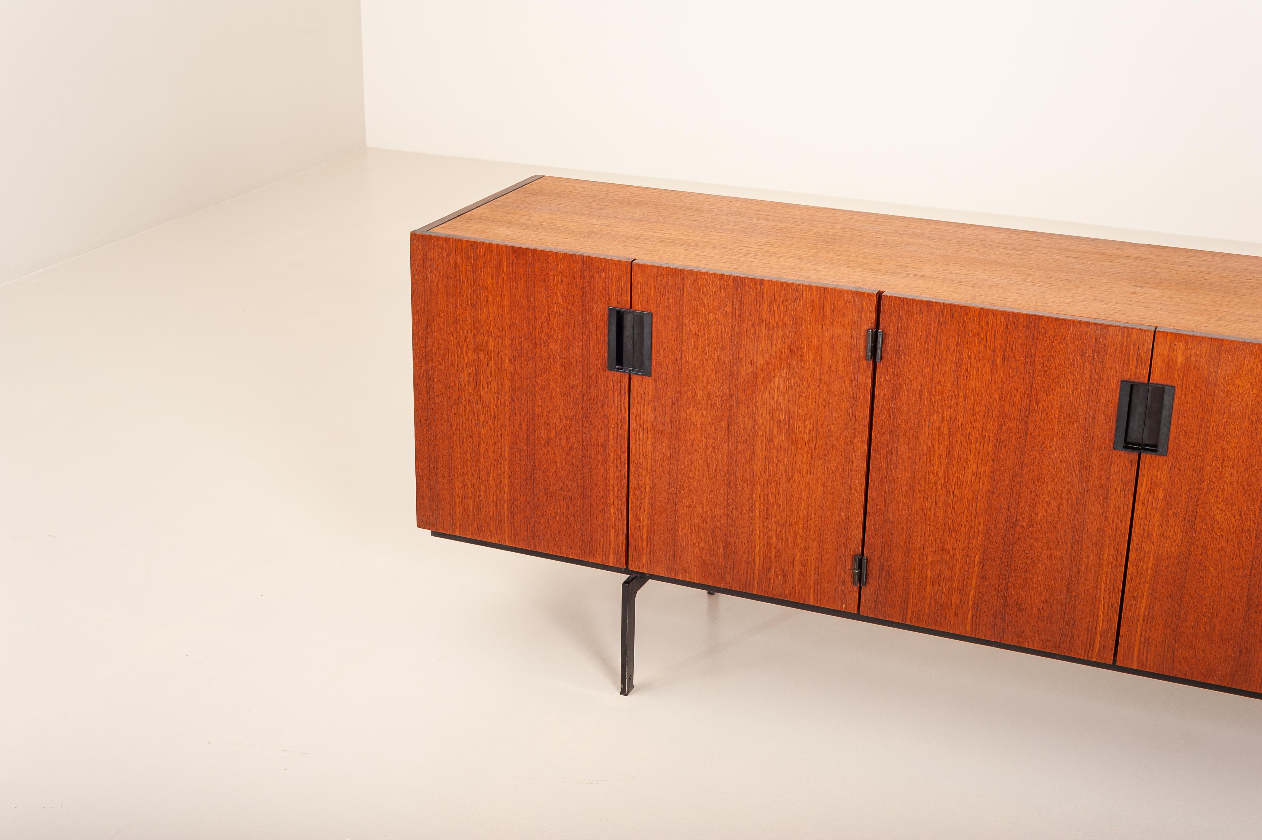 Essential and minimalistic sideboard model 'DU05' by Cees Braakman for UMS Pastoe from the Japanese series. .

Designed in the 1958, this sideboard consists of a cabinet made of teak veneer, peculiar black integrated handles and a discreet black