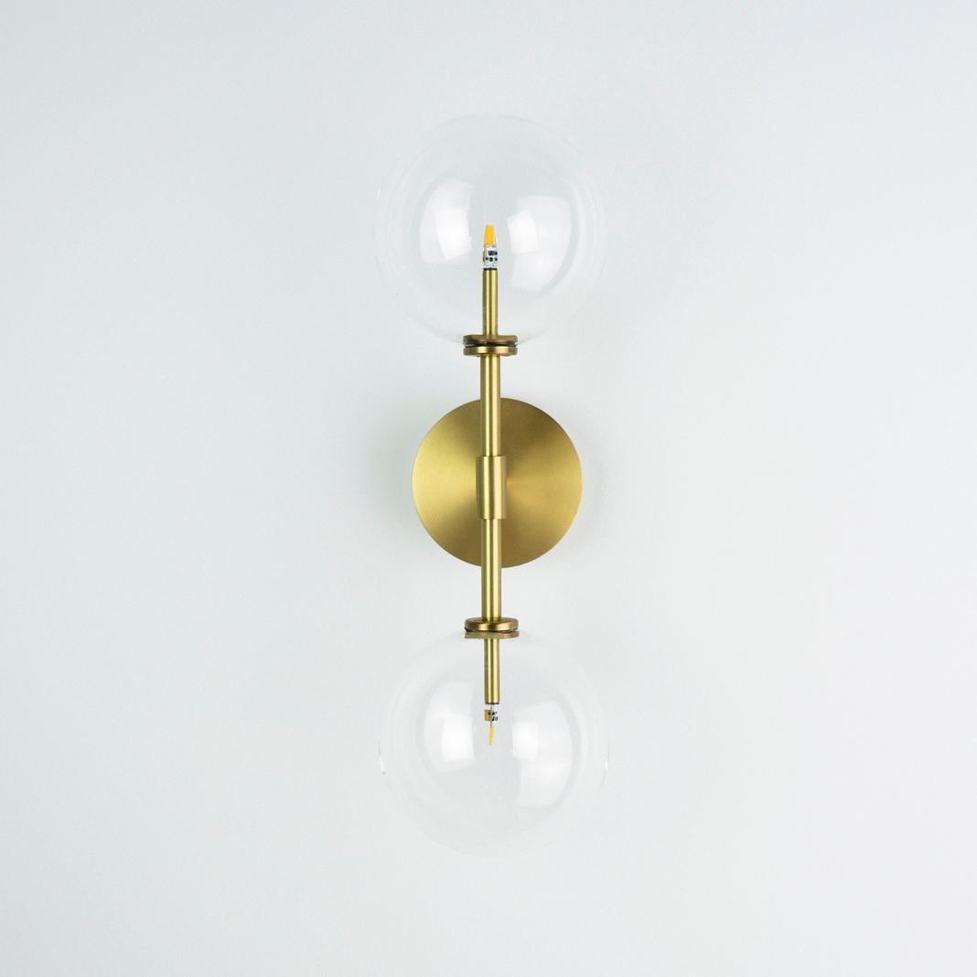 Dawn Dual brass wall sconce by Schwung
Dimensions: W 19 x D 15 x H 47.5 cm
Materials: Natural brass, hand blown glass globes

Finishes available: Black gunmetal, polished nickel
  

 Schwung is a german word, and loosely defined, means energy or