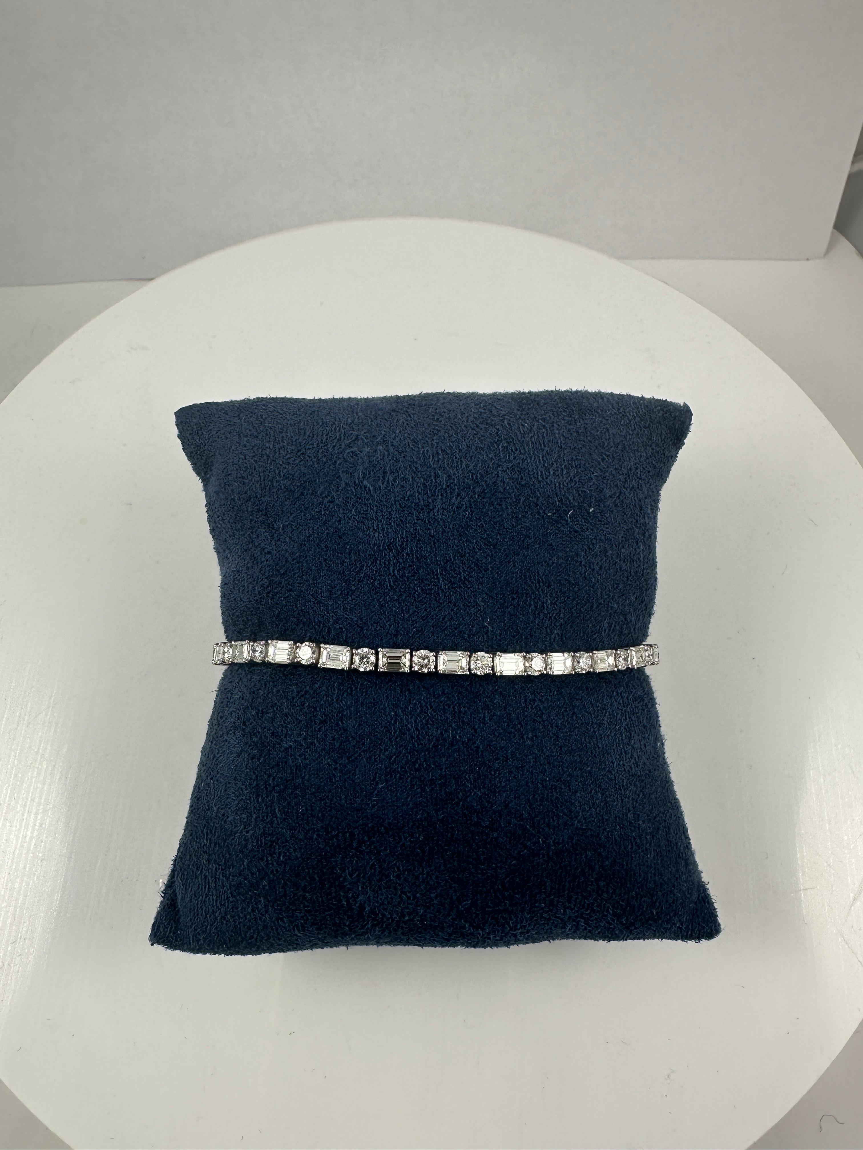 A modern take on timeless luxury—this 7-inch tennis bracelet showcases a sleek alternating pattern of all-natural, emerald-cut and round brilliant diamonds, masterfully set in 14K white gold.

The design balances geometry and sparkle, with 6.60