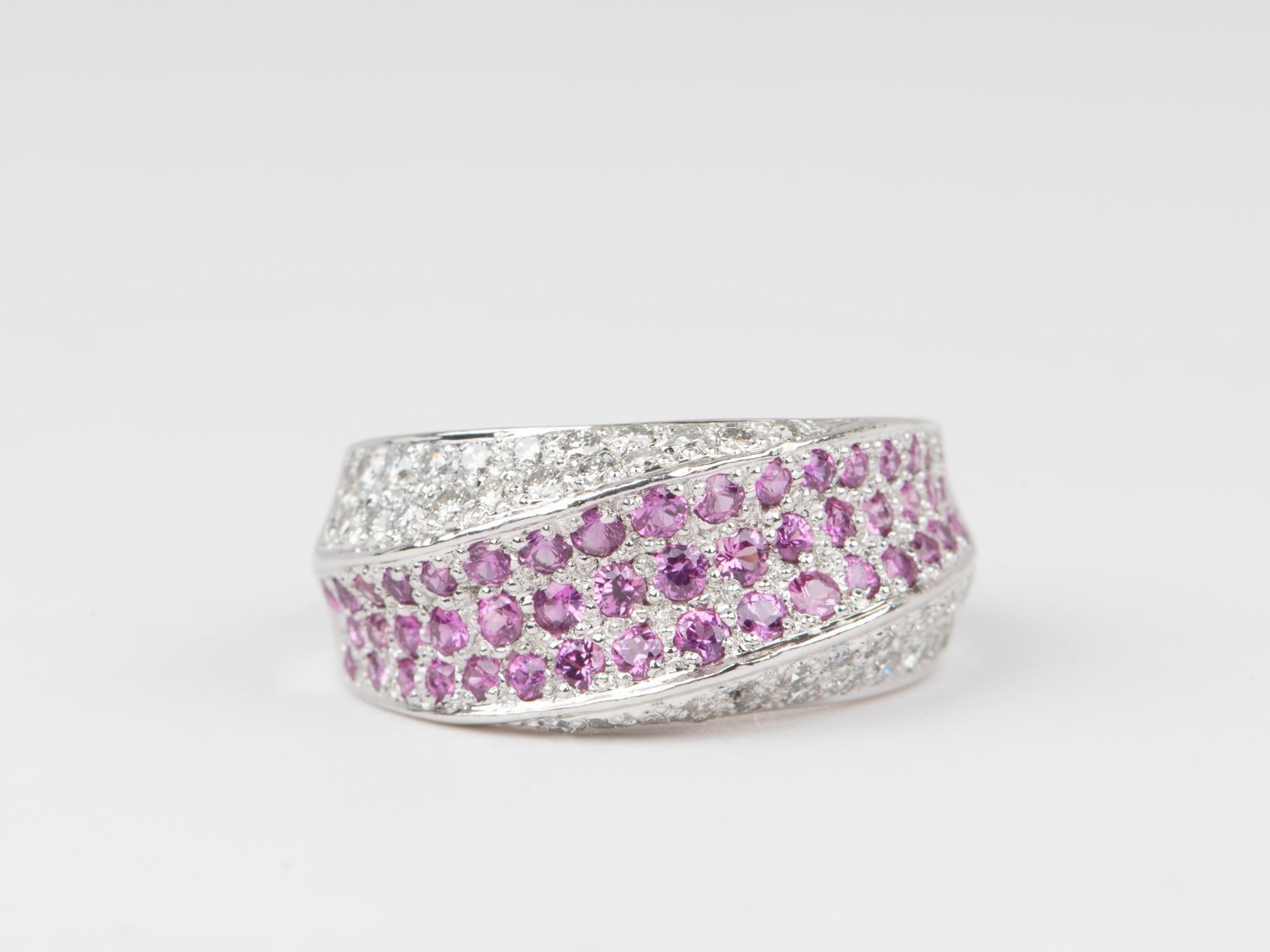 ♥ Dual Tone Three Dimensional Diamond and Pink Sapphire Pave Wide Band Ring 18K Gold PT900 8.1g
♥ The design measures 9.2mm in length (North South direction), 21mm in width (East West direction), and sits 4mm tall from the finger. Band width is