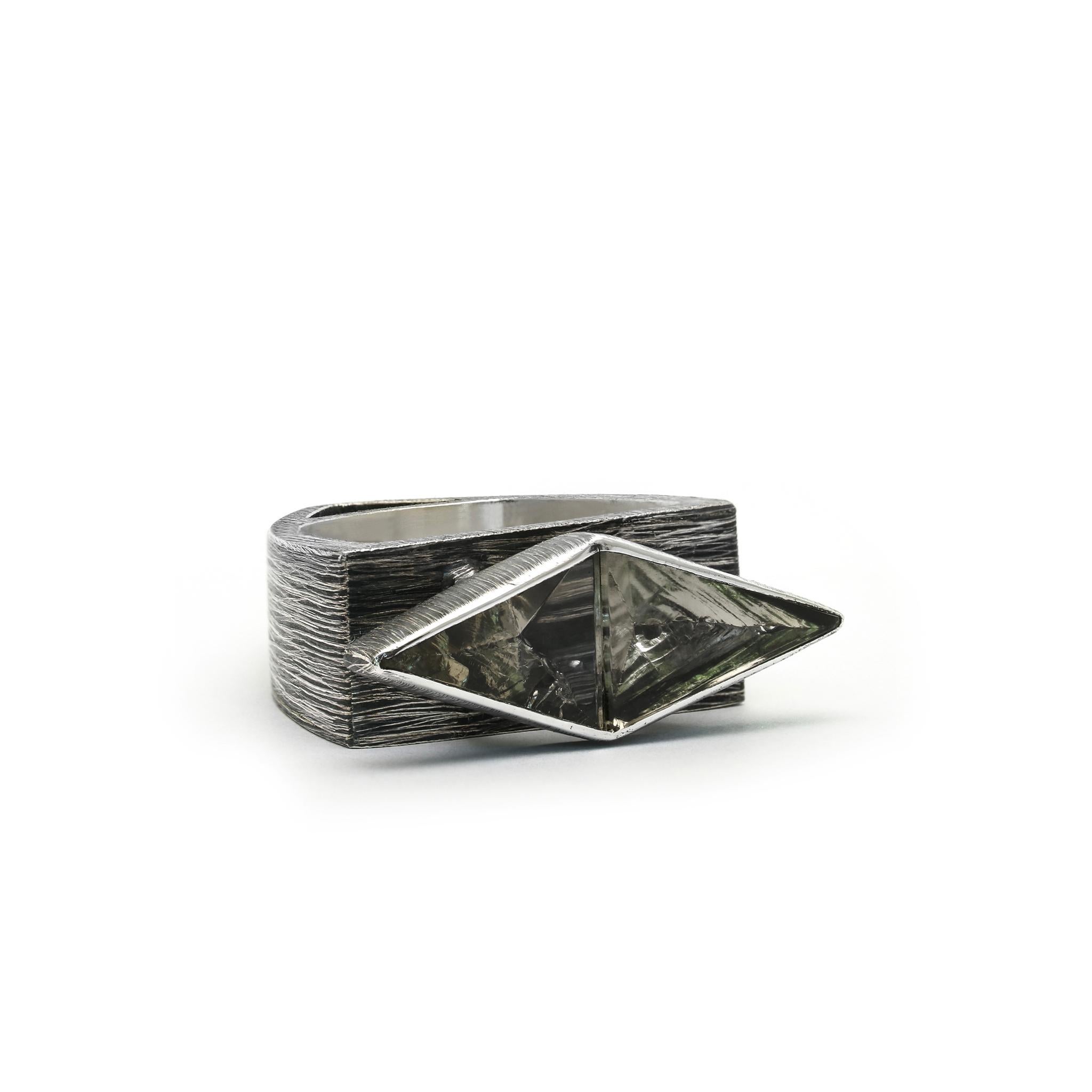 A symmetrical pair of rough-hewn crystal triangles float together, resembling an inverted arch over the band of the ring. 
925 Sterling Silver Etched and Oxidized
Set with 1 x 2,2cm rough-hewn crystals 
Due to the use of natural minerals in our