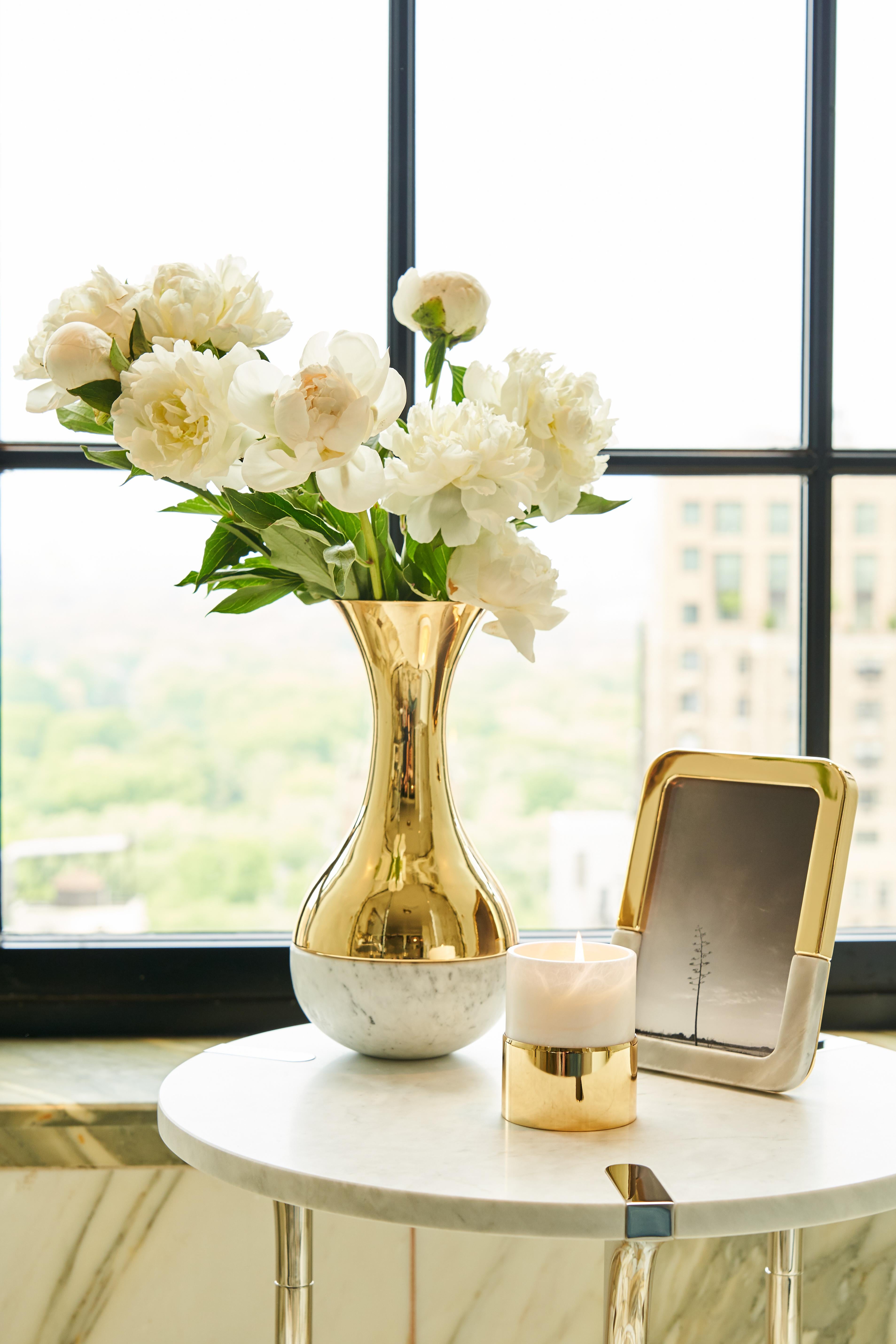 Our Dual collection unites two very different material: honed Italian marble, and polished metal. It is designed to create moments of grace: a bud-vase that holds a single stem of one's favourite flowe, candlesticks that adorn the table when friends