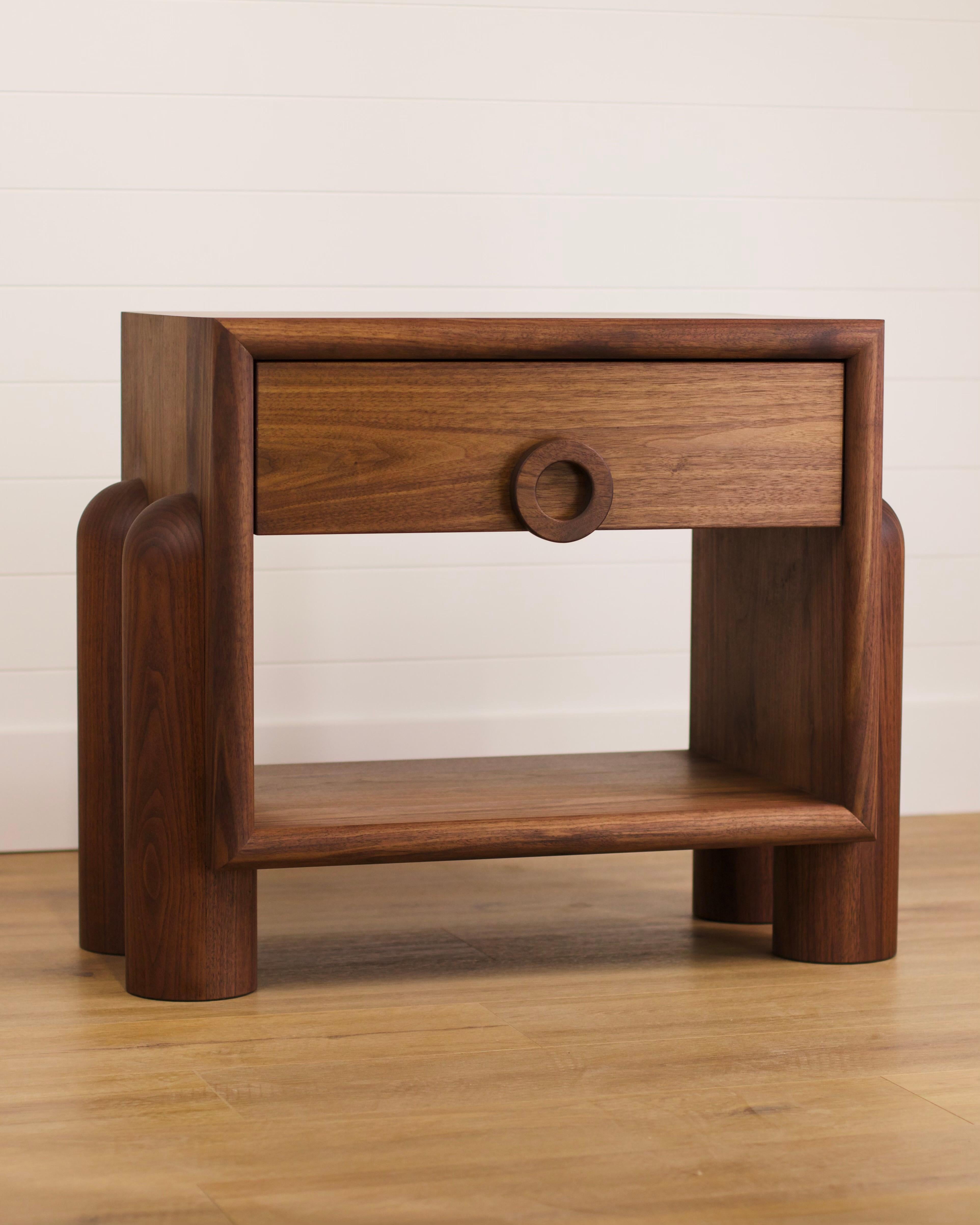 The Dub Series collection by Michael Kussman. New for 2024 - tuck and roll front face nightstand with single drawer. 18” solid hand turned legs that appear to be projecting through the cabinet.  All solid walnut hardwood with ash drawers.

Also