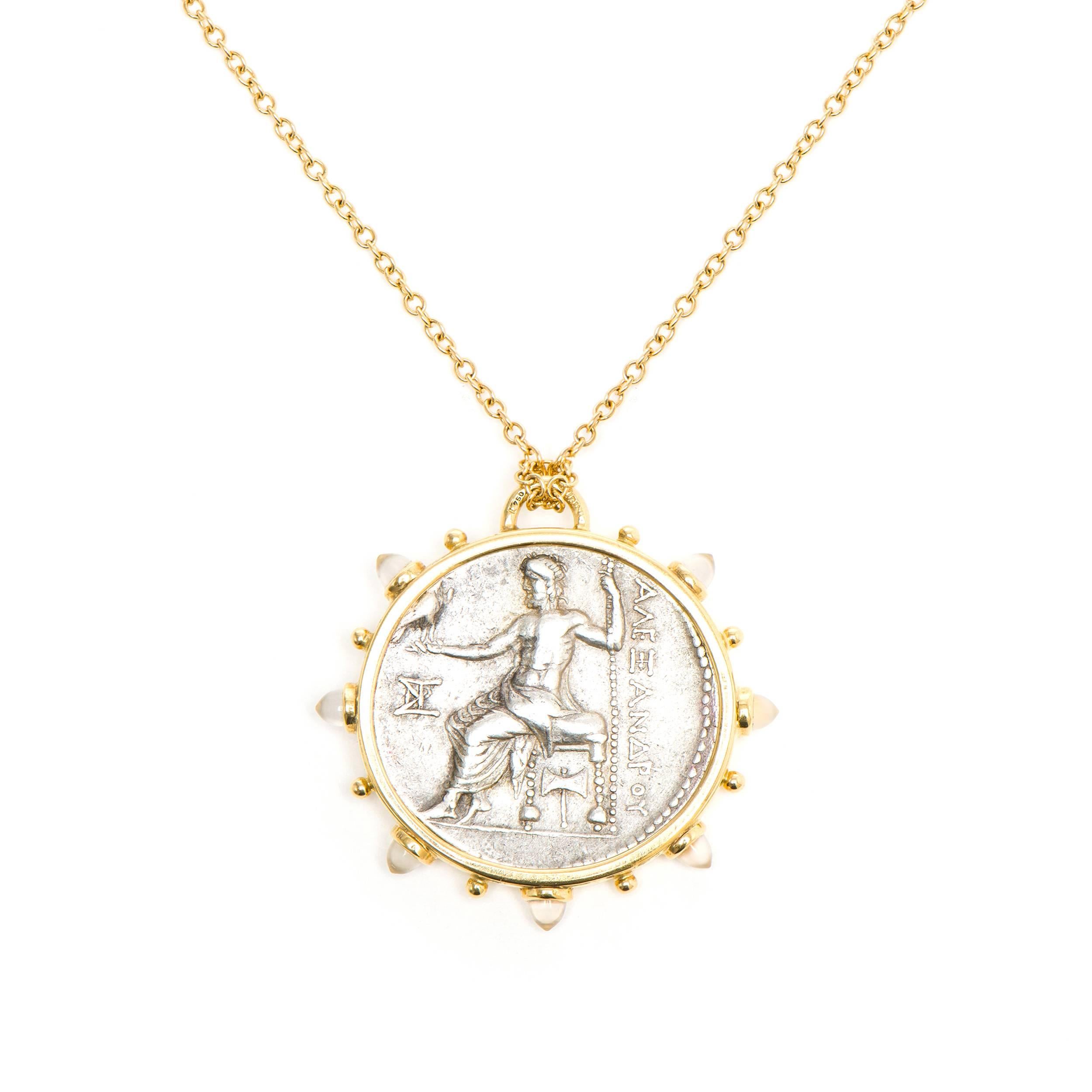This DUBINI coin necklace from the 'Empires' collection features an authentic Macedon coin from 336-323 B.C set in 18K yellow gold with bullet moonstone cabochons. 

Depicted on the coin: Alexander with a bust of Heracles on the obverse and a seated