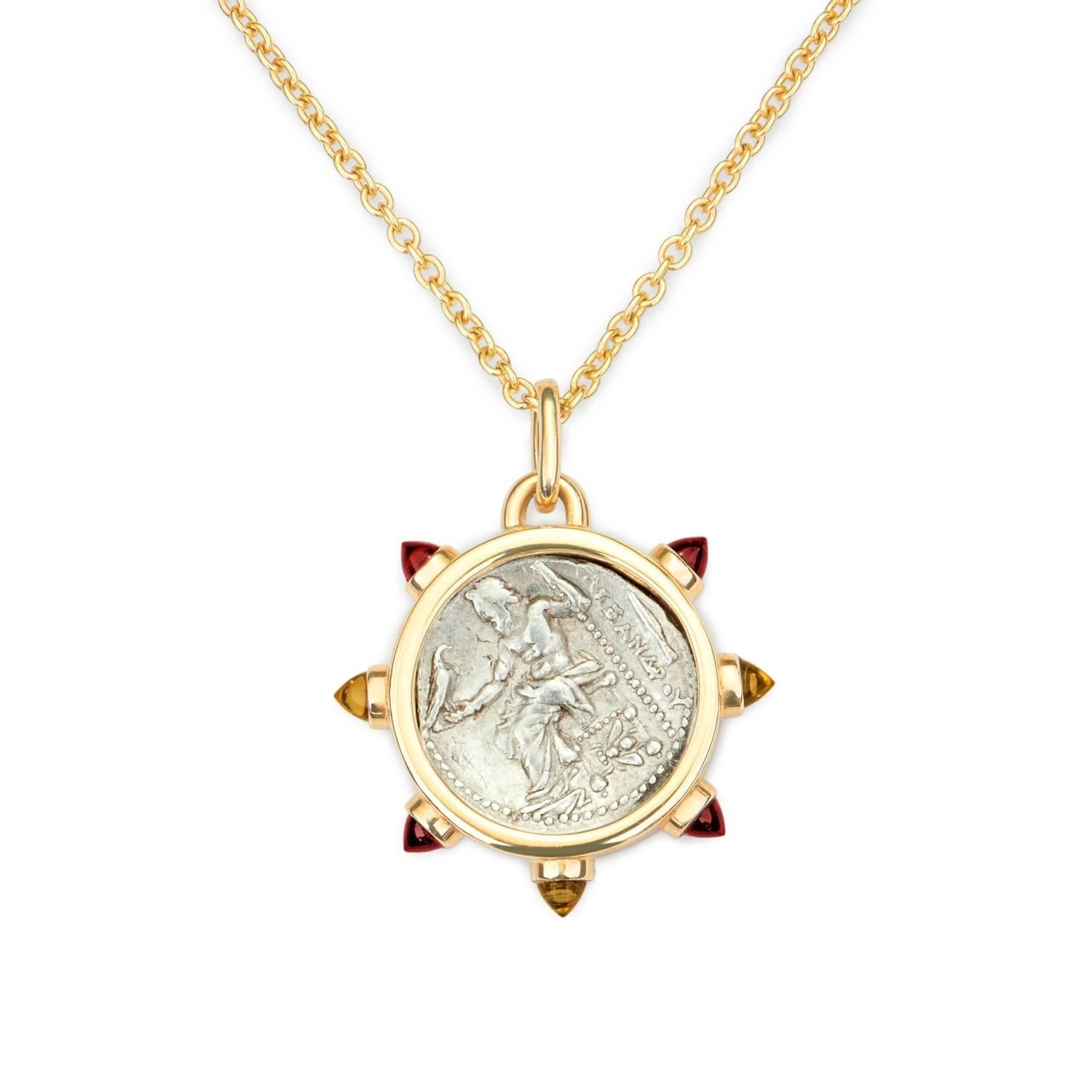 This DUBINI coin necklace from the 'Empires' collection features an authentic coin from 336-323 B.C. set in 18K yellow gold with garnet and citrine bullet cabochons.

Depicted on the coin: Alexander with a bust of Heracles, on the obverse and a