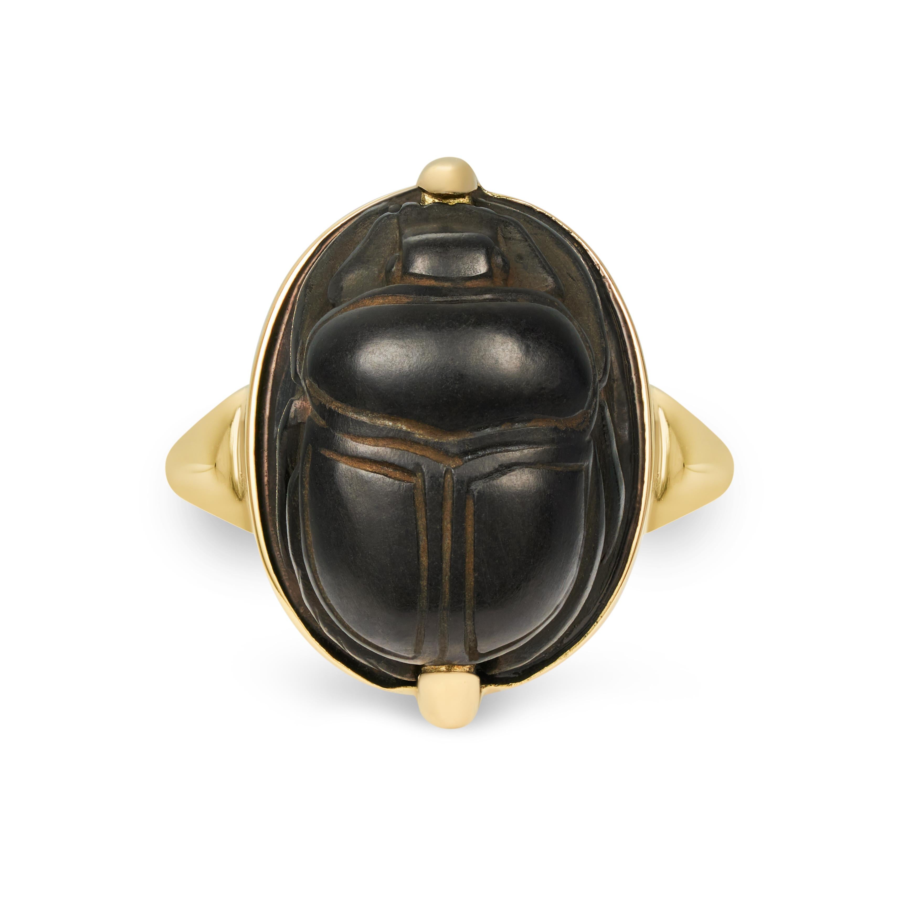 This DUBINI ring features an ancient Egyptian scarab circa 1085-713 B.C. set in 18K yellow gold.

A black stone scarab with an oval body and a gently rounded upper side detailing the clypeus, prothorax, and wings. This scarab has wonderfully moulded