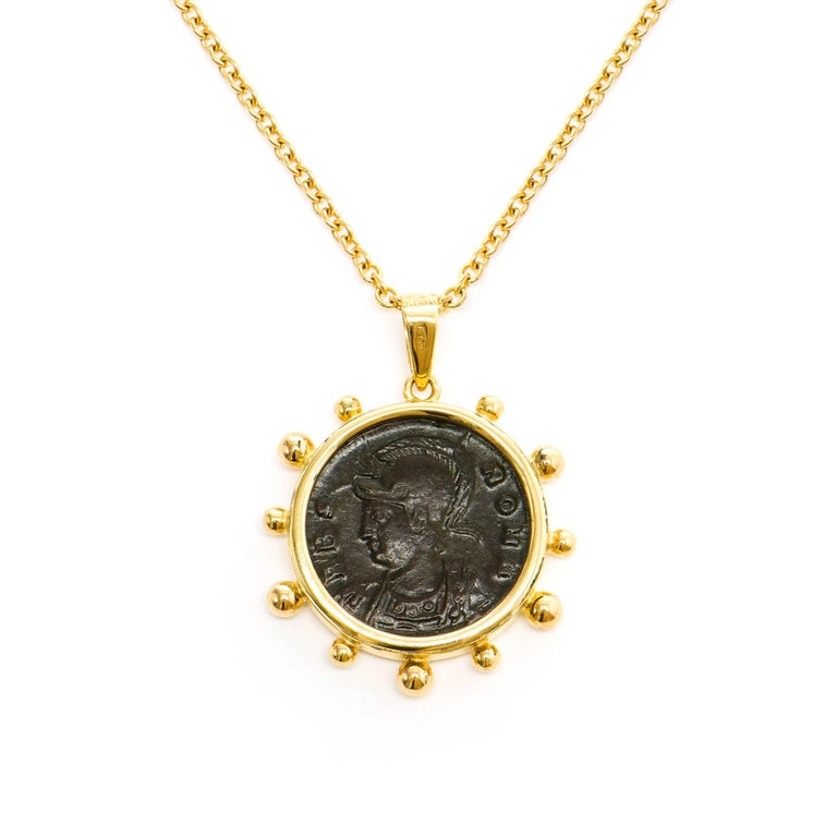 This DUBINI coin necklace from the 'Empires' collection features an authentic Roman Imperial coin minted circa 330-335 A.D set in 18K yellow gold.

Depicted on the coin: She-wolf suckling Romulus and Remus with stars above on the obverse and