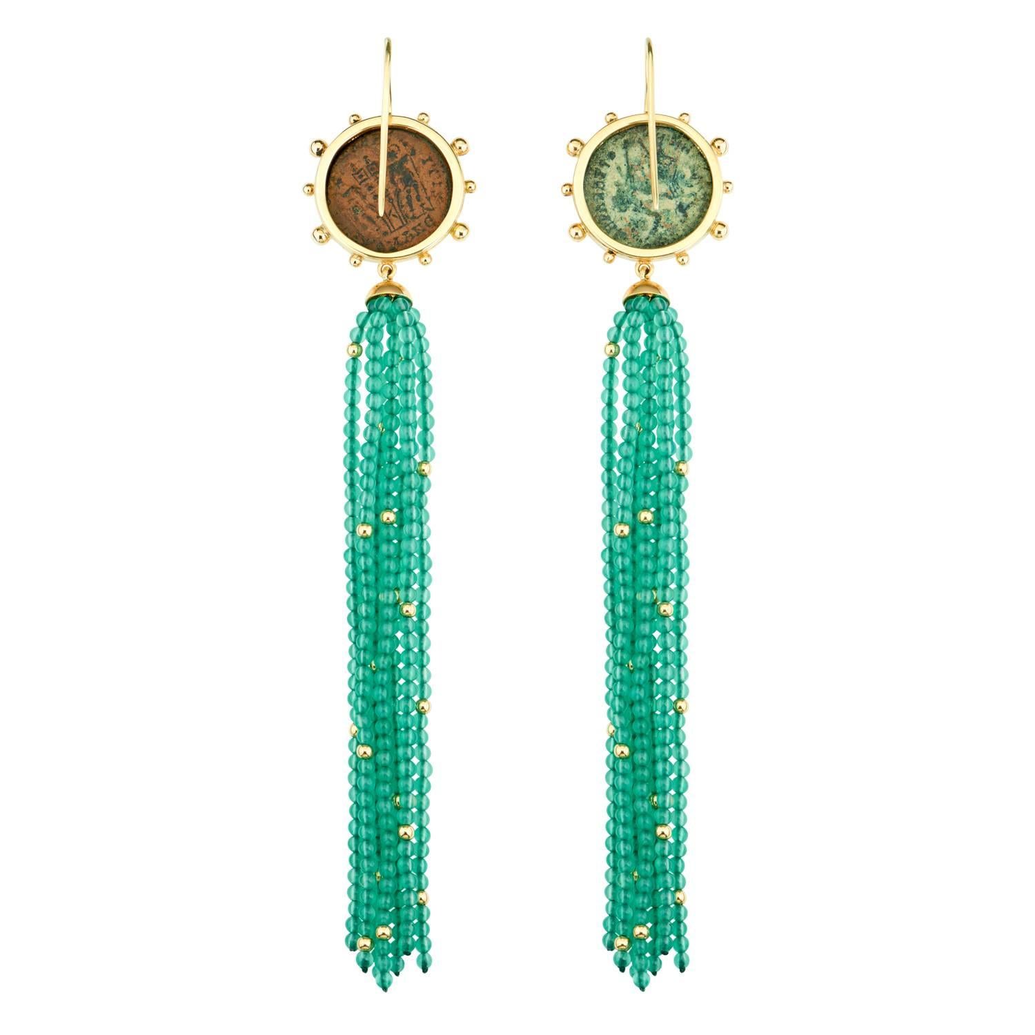These Dubini coin earrings from the 'Empires' collection feature authentic Roman Imperial bronze coins set in 18K yellow gold with green agate and gold beaded tassel.

* Due to the unique process of hand carving coins in ancient times, there may be
