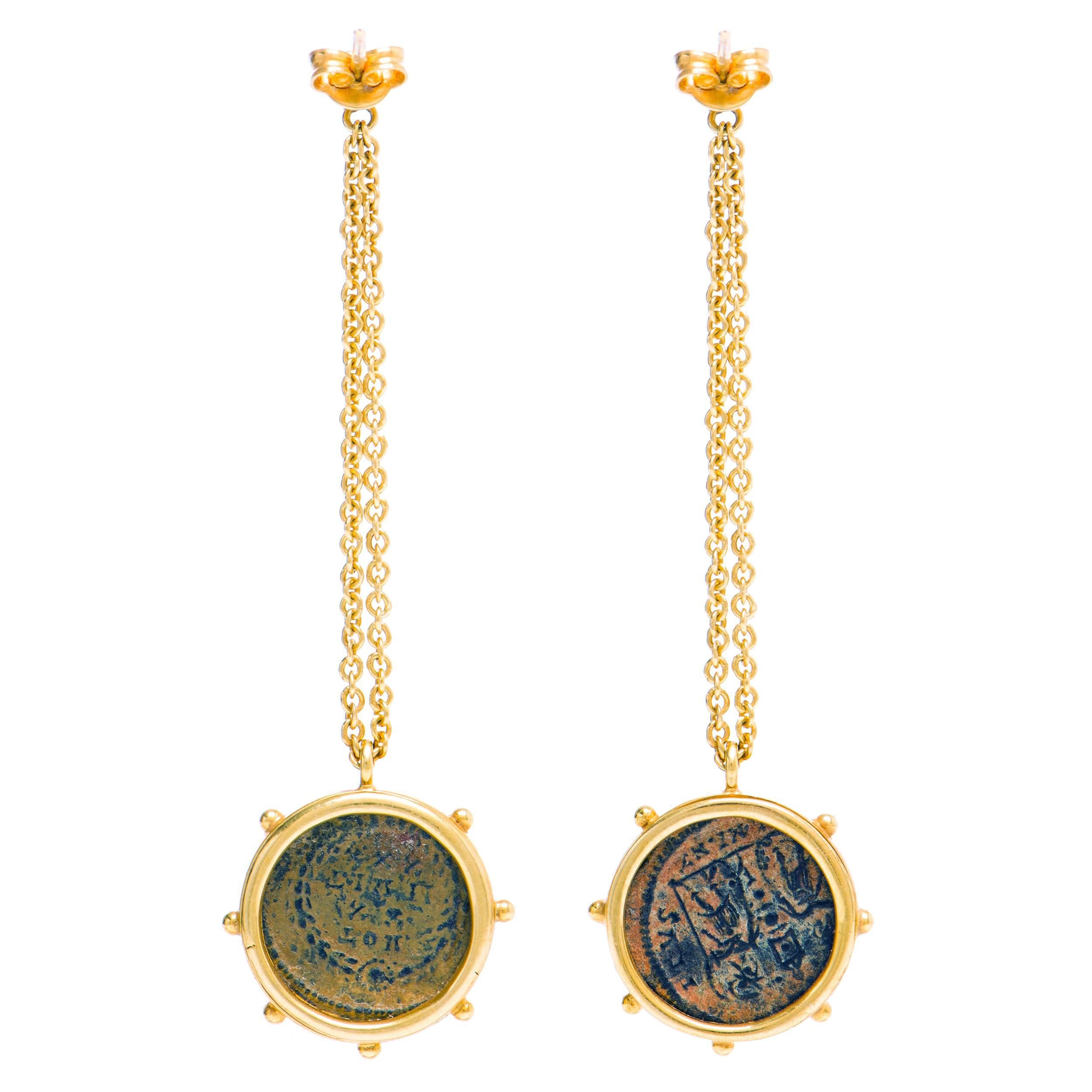 These DUBINI coin earrings from the 'Empires' collection feature authentic Roman bronze coins set in 18K yellow gold.

* Due to the unique process of hand carving coins in ancient times, there may be a few stylistic differences from the image shown.