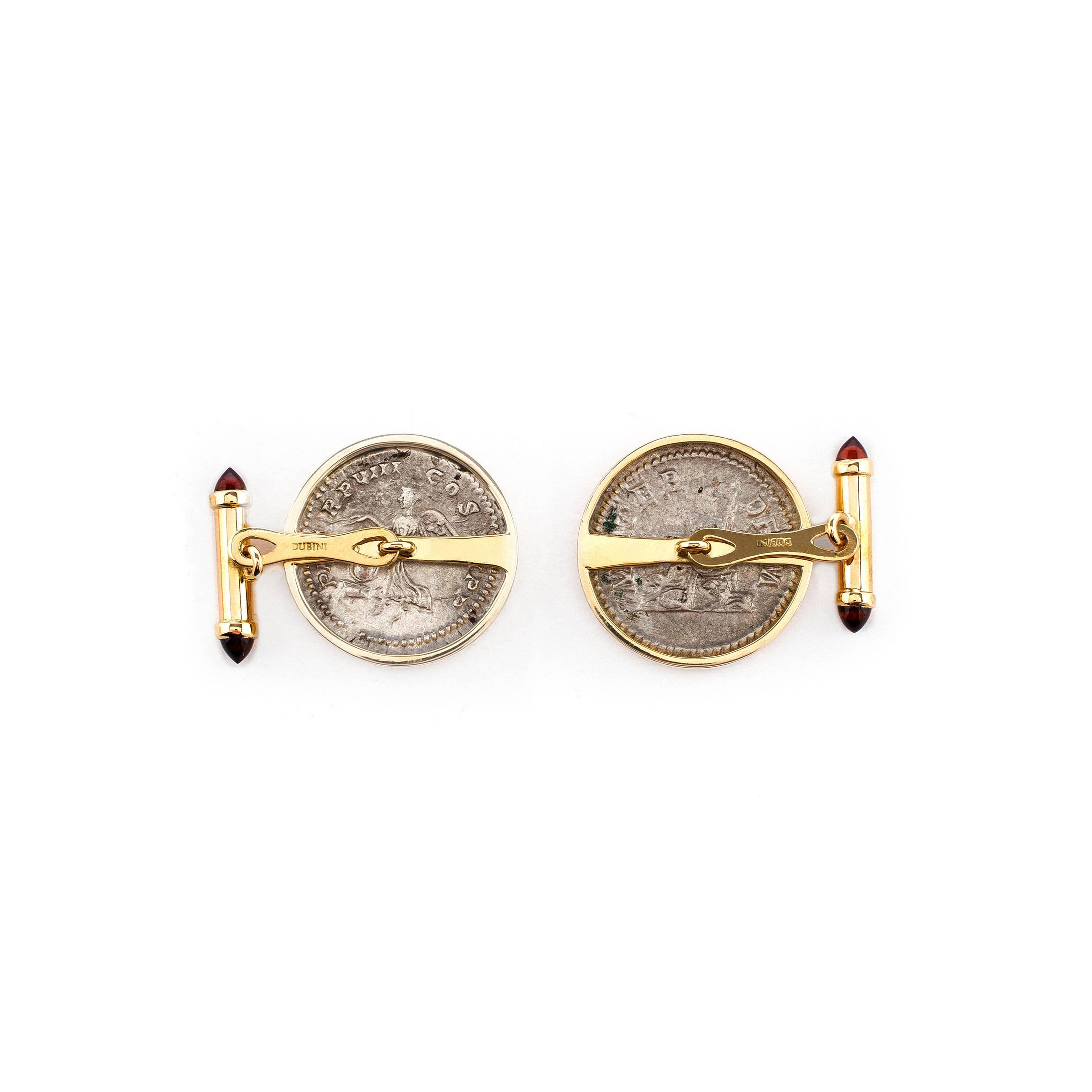 These DUBINI coin cufflinks from the 'Empires' collection feature authentic Roman Imperial silver coins minted circa 210 - 211 A.D set in 18K yellow gold with garnet bullet cabochons.

*Each piece is provided with a Certificate of