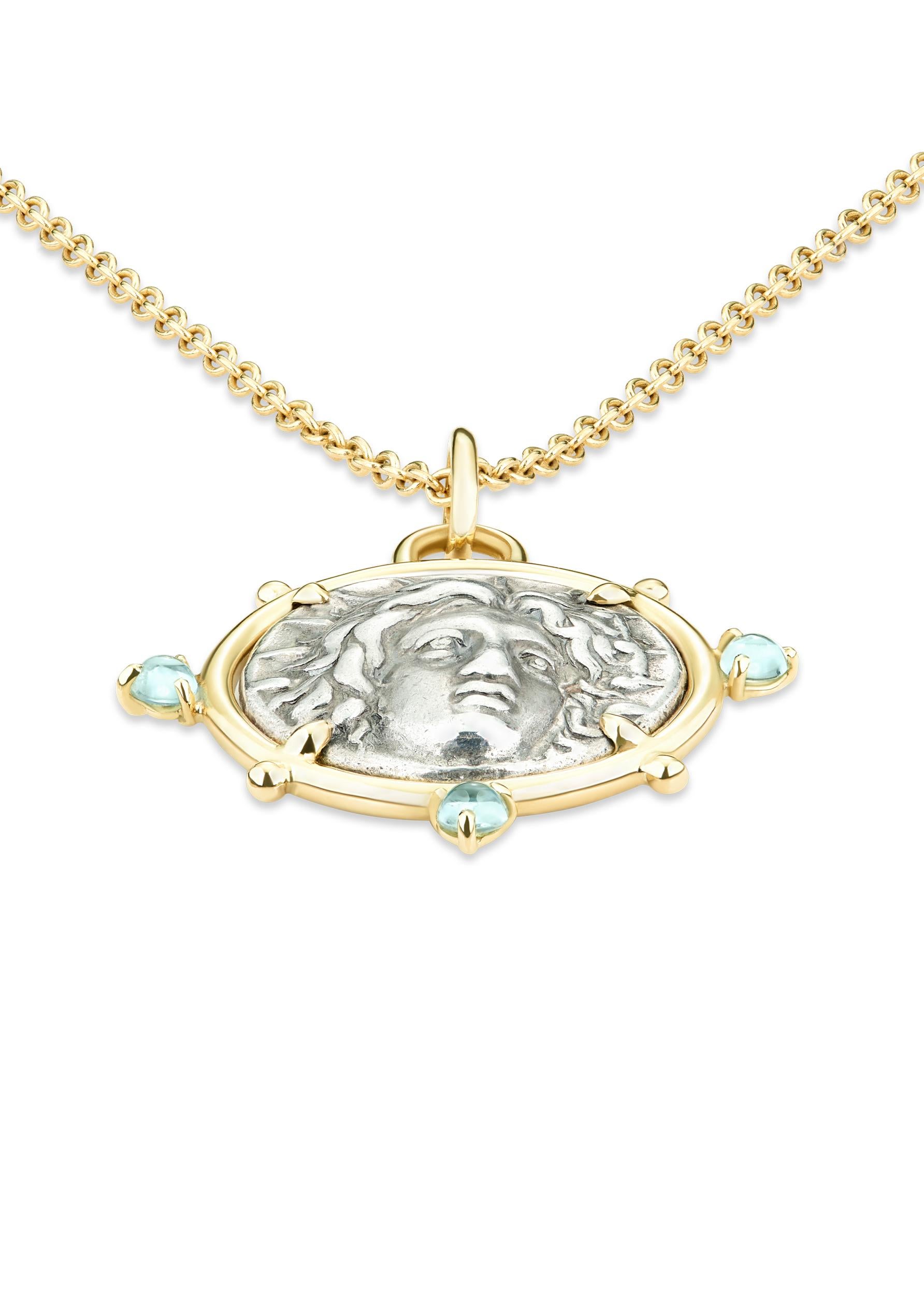 This DUBINI coin necklace from the 'Empires' collection features an authentic silver coin from Istros, Moesia dating circa 4th century B.C. set in 18kt yellow gold with peridot and aquamarine cabochons.

Coin Ø 19mm
Chain Length: 47cm

DEPICTED ON