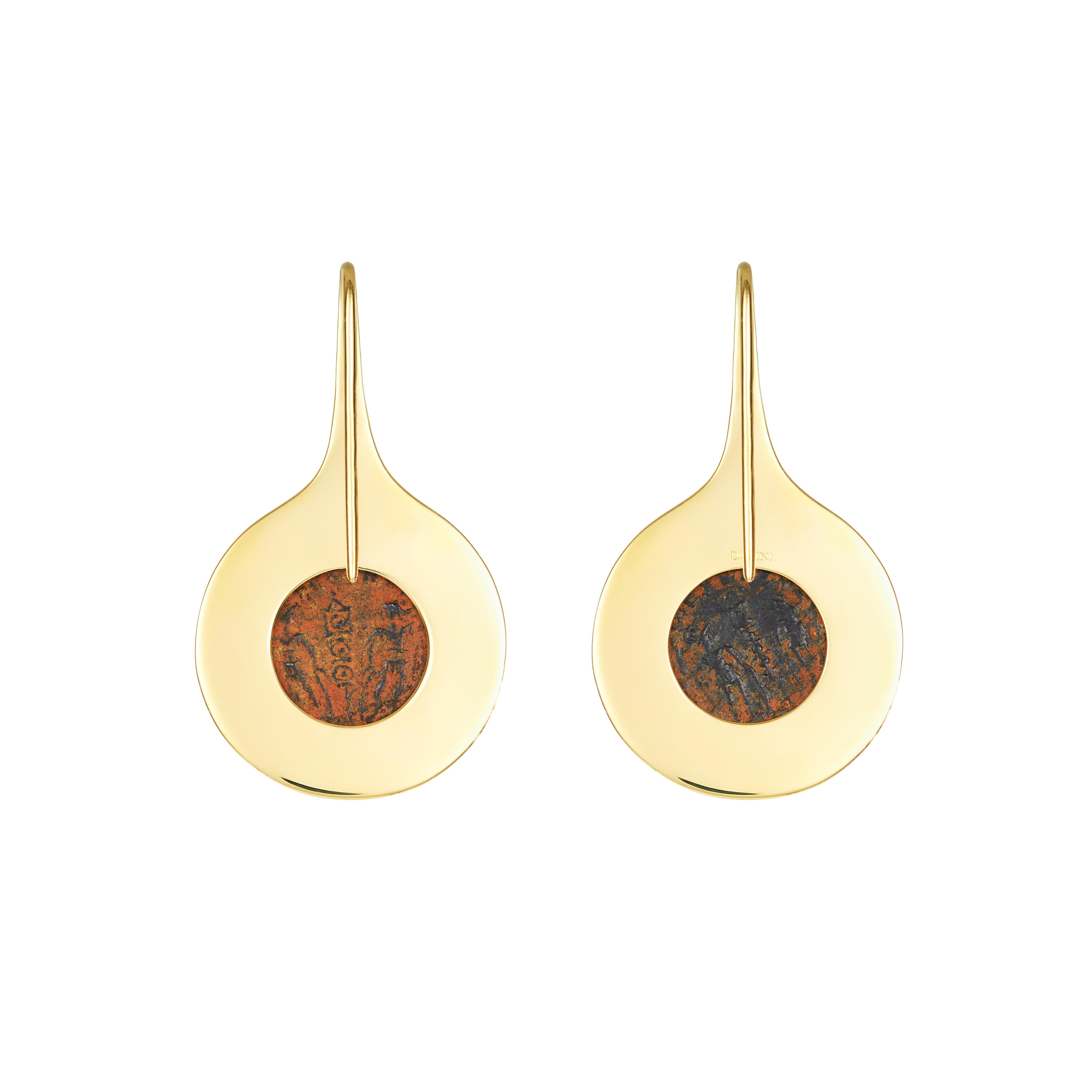 These Dubini coin earrings from the 'Empires' collection feature authentic Roman Imperial bronze coins set in 18K yellow gold.

Coin diameter: 11mm

Unique pair of earrings who's mirror like surface showcases the beautiful set of patina