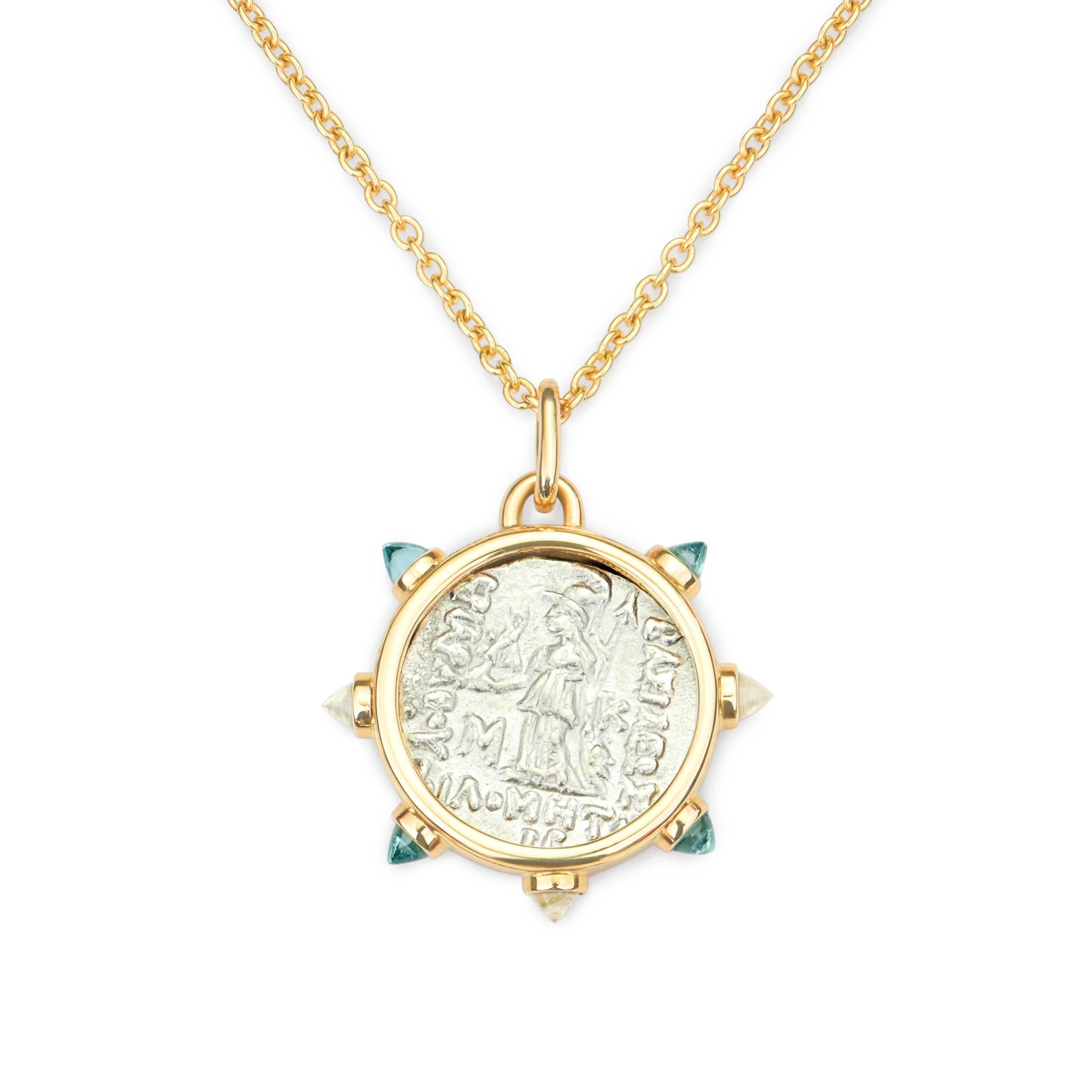 This DUBINI coin necklace from the 'Empires' collection features an authentic coin from 116-101 B.C. set in 18K yellow gold with sky topaz and swiss topaz bullet cabochons. 

DEPICTED ON THE COIN: 
Young Ariarathes VII Philometor on the obverse,