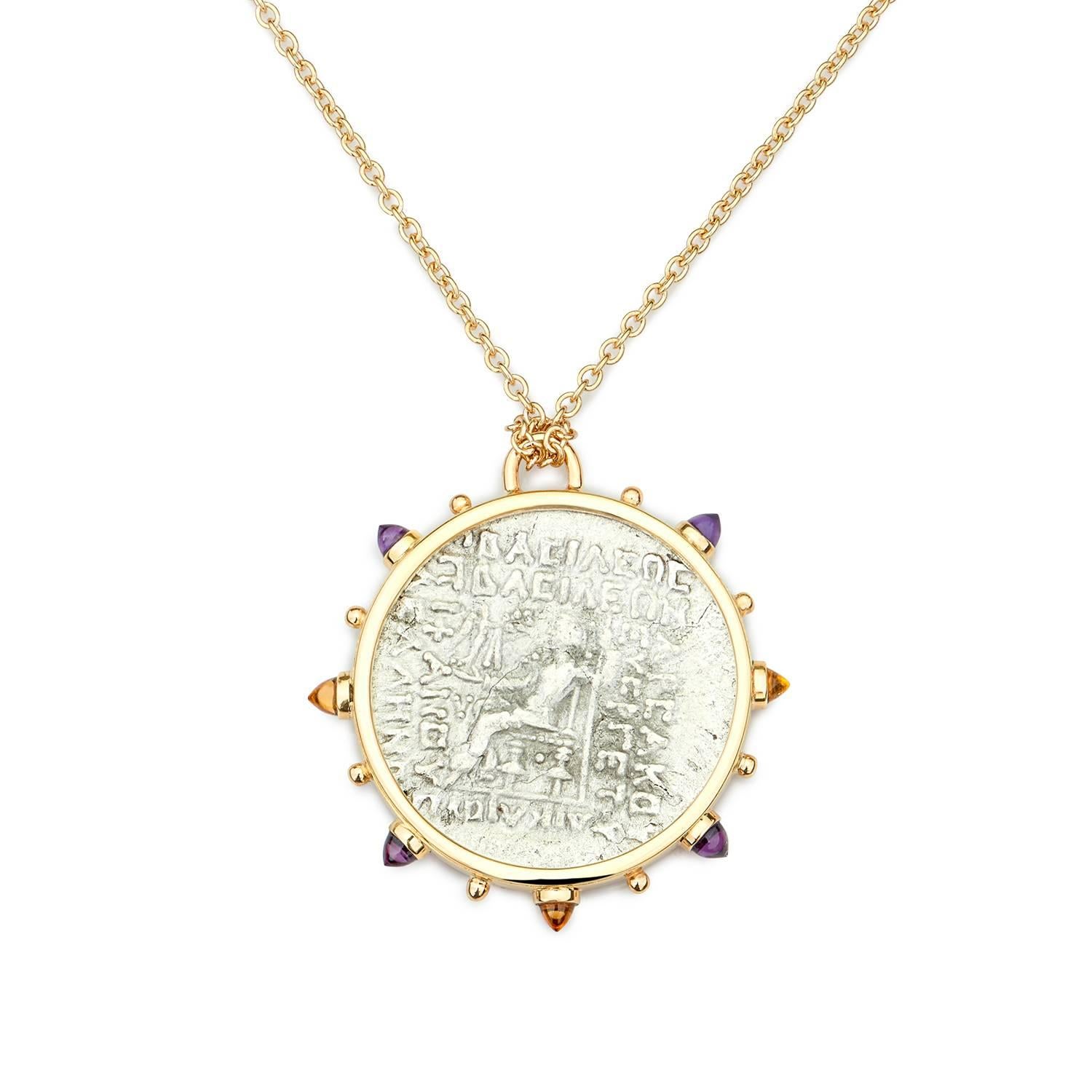 This DUBINI coin necklace from the 'Empires' collection features an authentic Parthian coin from 57-38 B.C. set in 18K yellow gold with bullet amethyst and citrine cabochons. 

Depicted on the coin: Oredes II, one of the kings of Parthia, on the